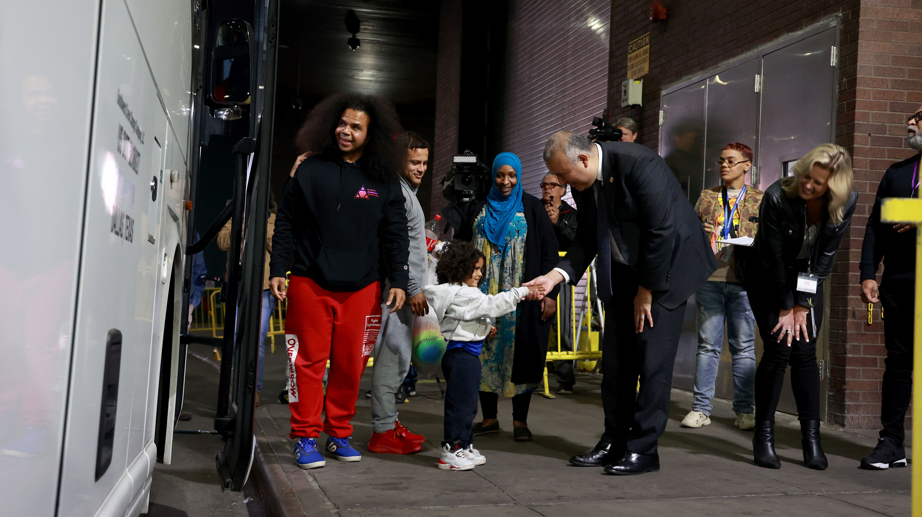 New York City Mayor's Office of Immigrant Affairs Commissioner Manuel Castro, center, welcomes migrants arriving at the Port Authority Bus Terminal in Midtown Manhattan on Sept. 6, 2023. Despite New York Mayor Eric Adams' recent rules restricting when buses can arrive, Southern states are sending buses of migrants to New Jersey, where many of them continue on to New York City.