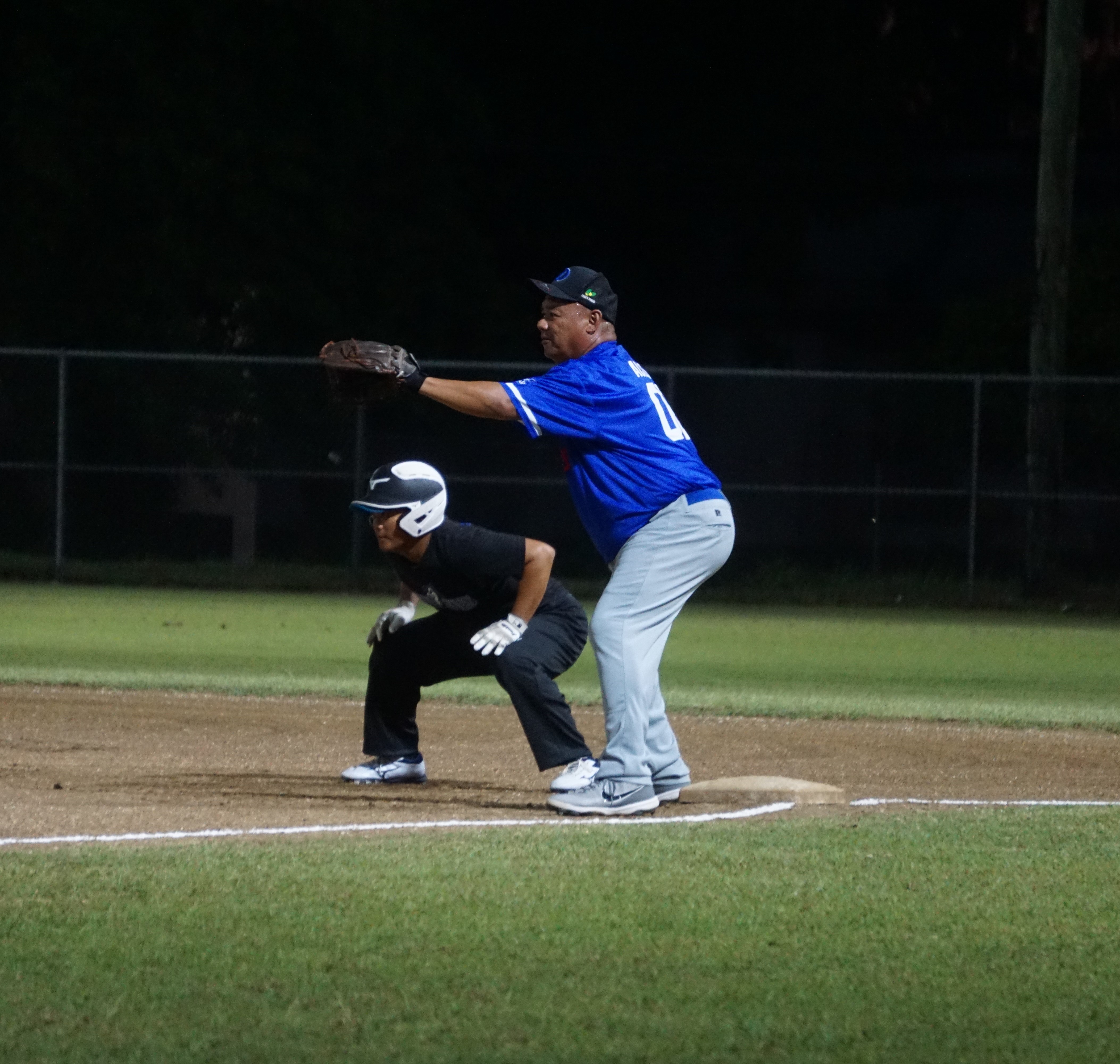 The Dodgers' first baseman, John Acosta, preps for the pickoff during an SBL Masters League game at the Francisco "Tan Ko" Palacios Baseball Field.