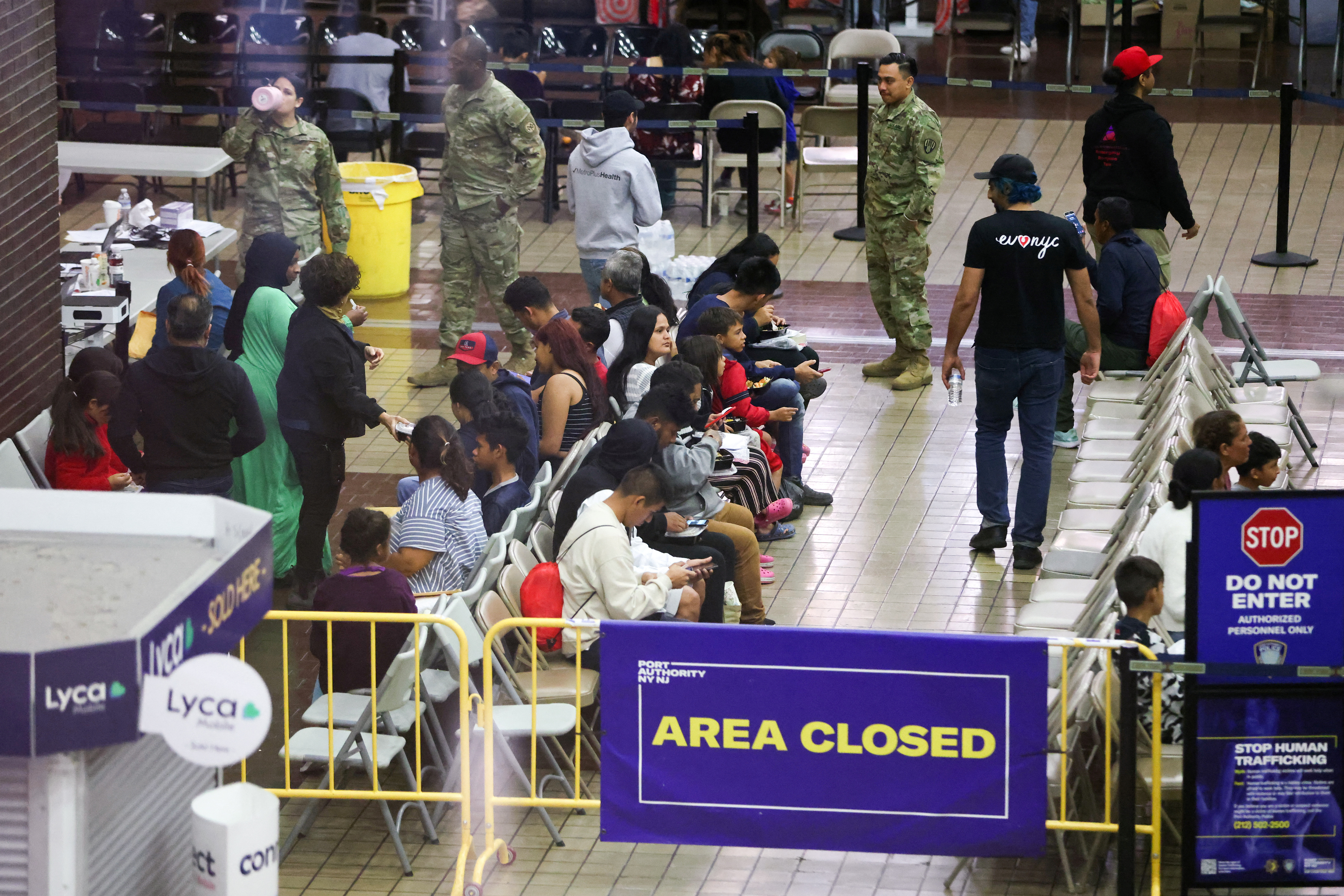 Migrants arriving from Texas by bus wait to be processed at the Port Authority bus terminal in New York City, U.S., May 10, 2023. 