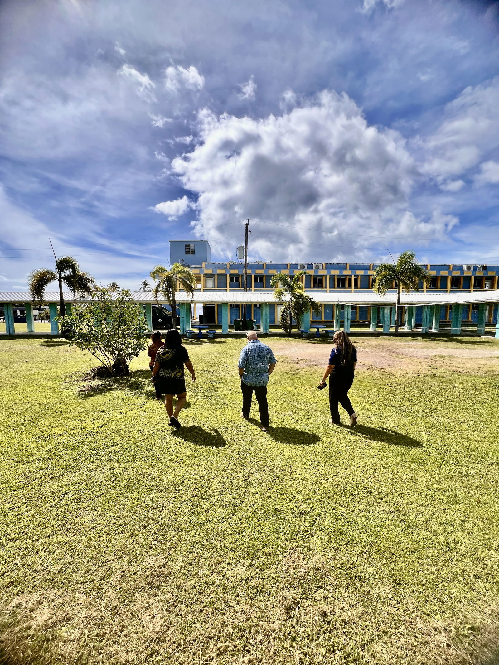 Principal Annette Calvo, Commissioner of Education Dr. Lawrence Camacho, and Special Education Program Director Donna M. Flores tour the campus of Dr. Rita Hocog Inos Junior-Senior High School.