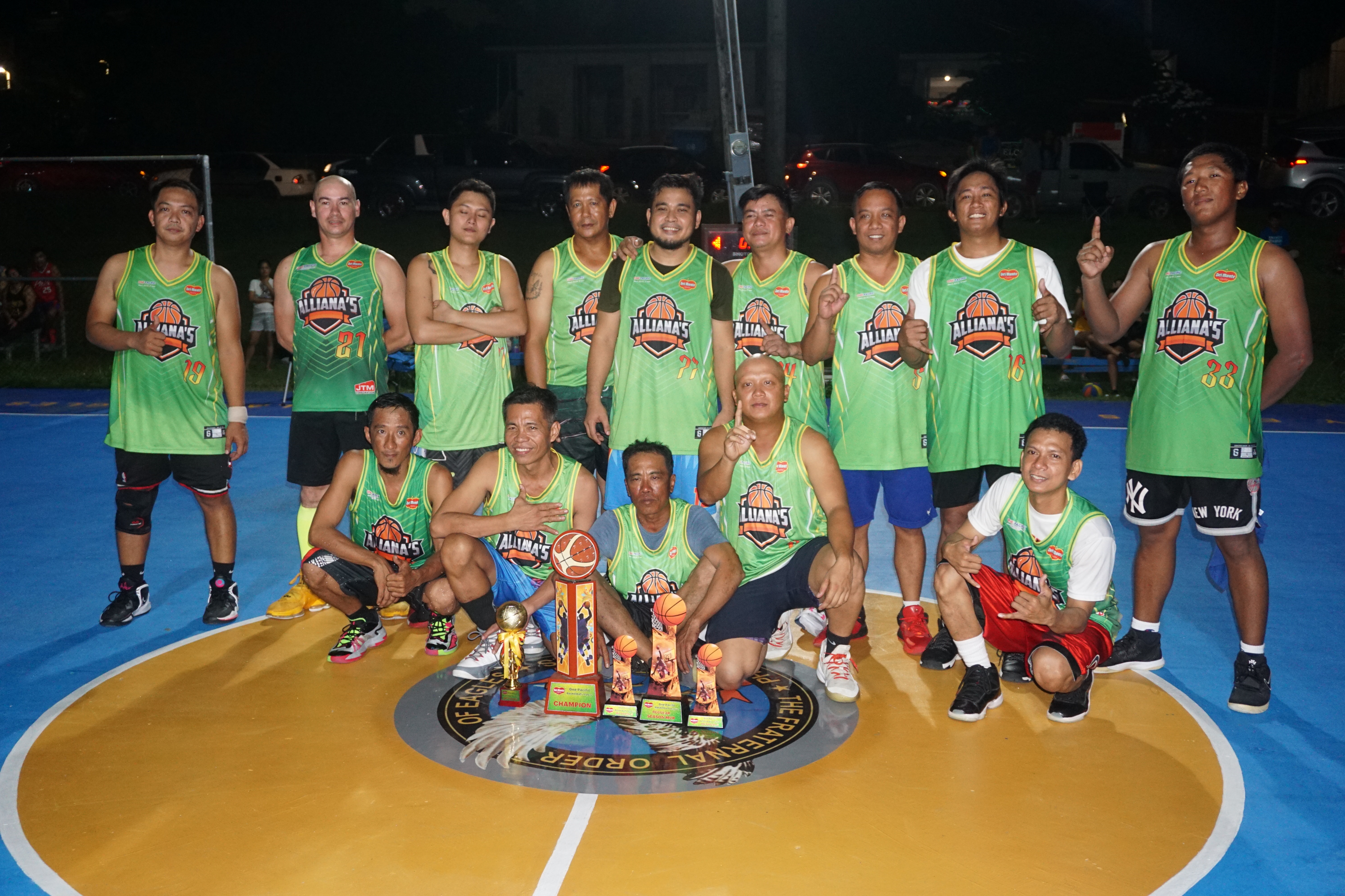 Team Alliana's players pose for a photo with their championship medals and trophy during the awards ceremony of the 2023 Pacific Saipan Promo Invitational Basketball League at the Gualo Rai basketball court on Wednesday.