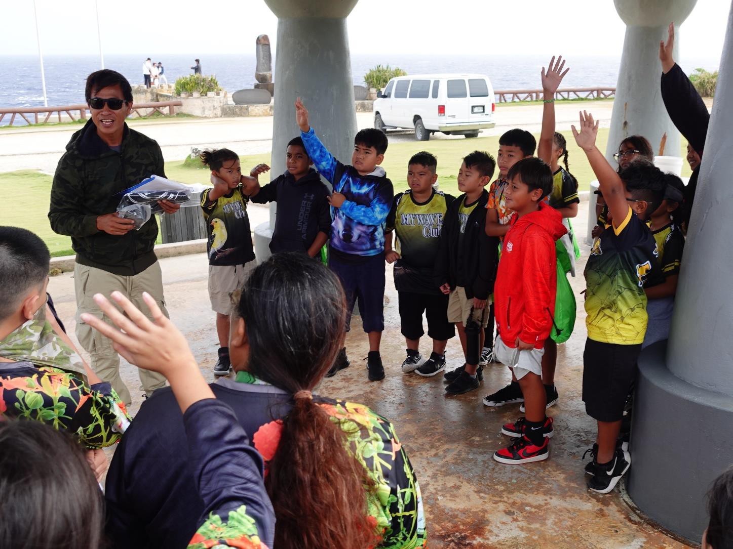 Fishguyz owner and PADI instructor Sydney Takahashi engages students with a presentation about ocean protection at Banzai Cliff in Marpi during the Marianas Tourism Education Council Tourism Summit on Jan. 19, 2024,