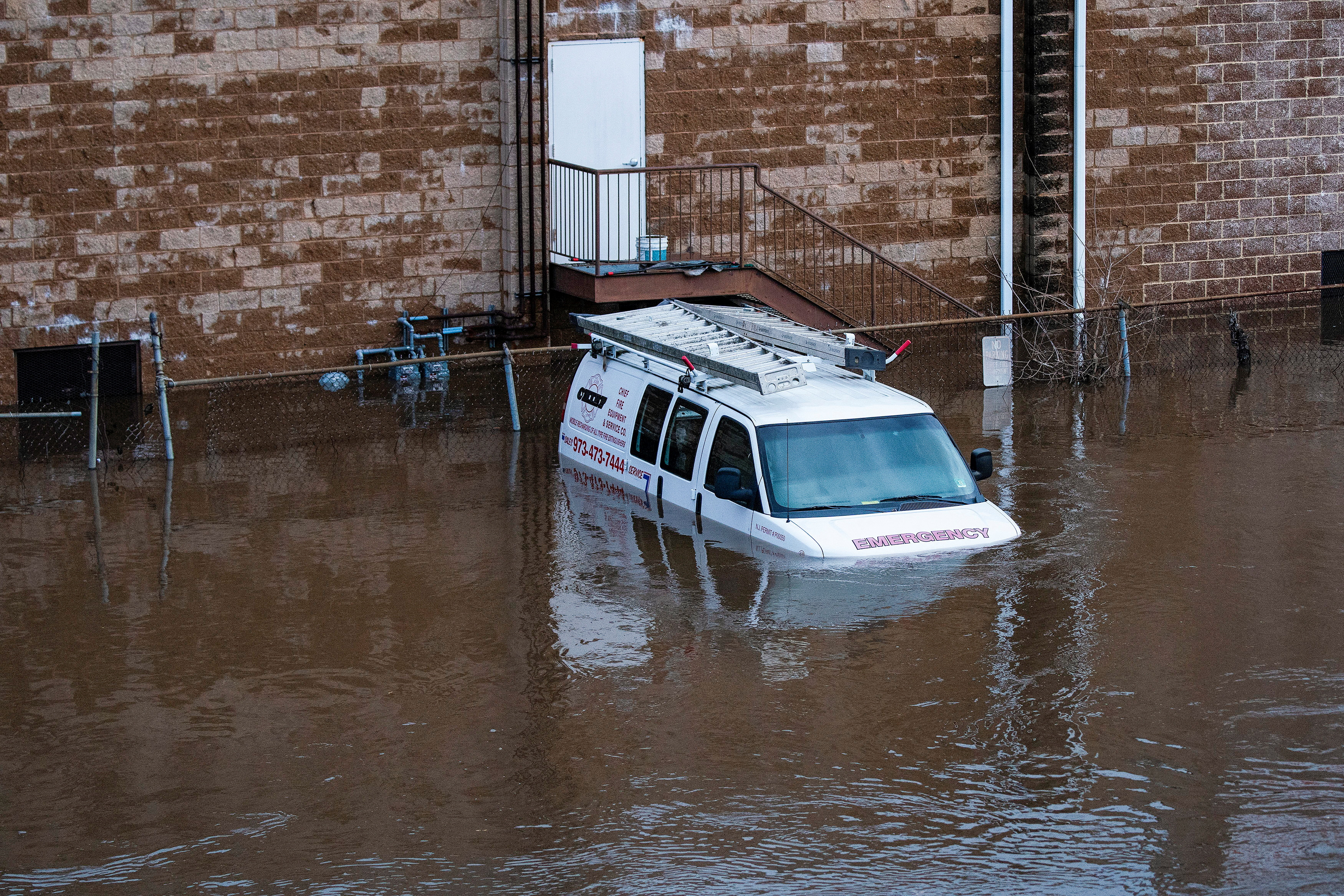 A car is flooded in a local street during the pass of a winter storm in Lodi, New Jersey, U.S., January 10, 2024. 