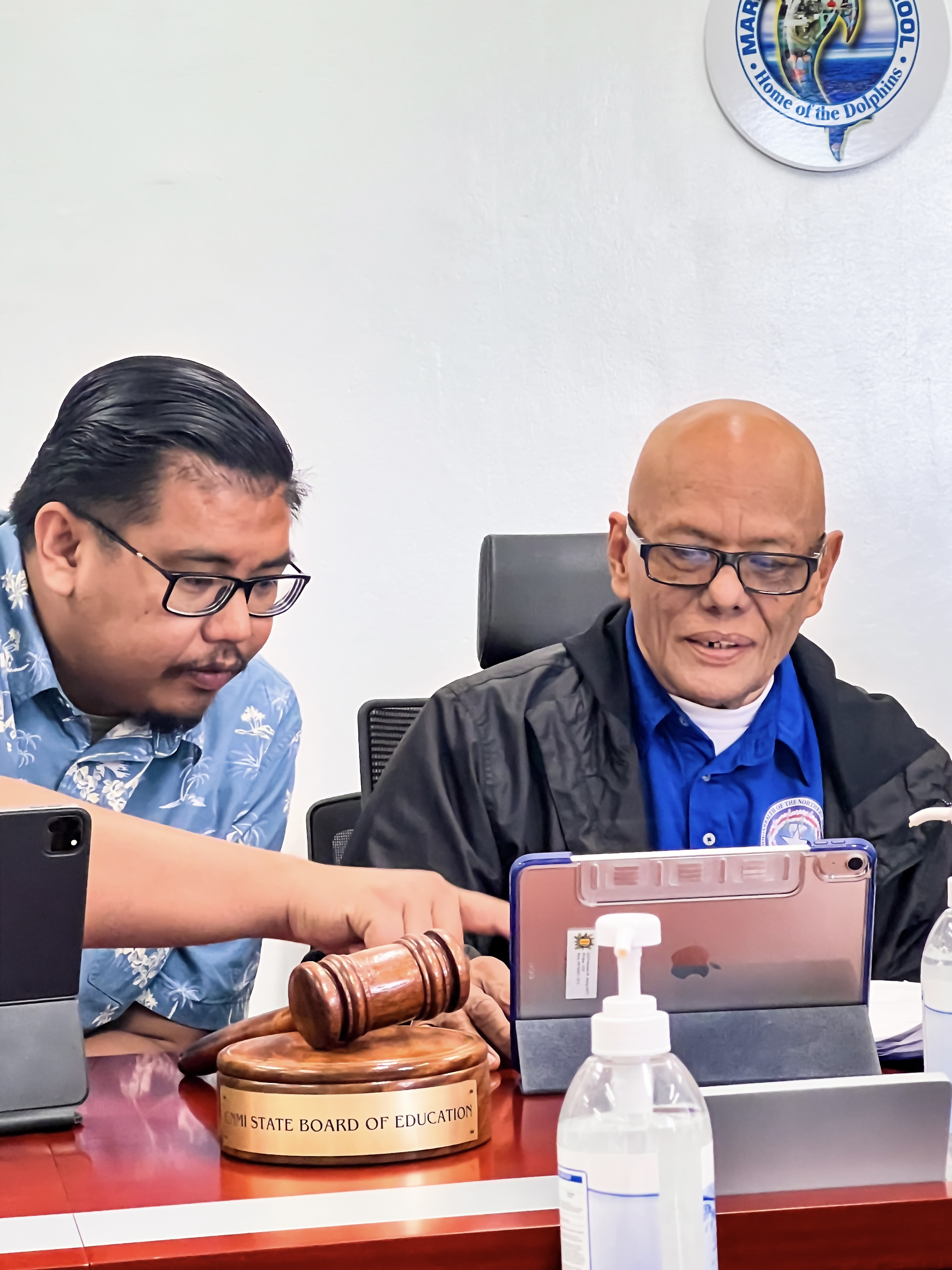 Newly elected Board of Education Chairman Herman M. Atalig of Rota, right, confers with his predecessor, Antonio L. Borja of Tinian, during the BOE meeting on Capital Hill Friday.