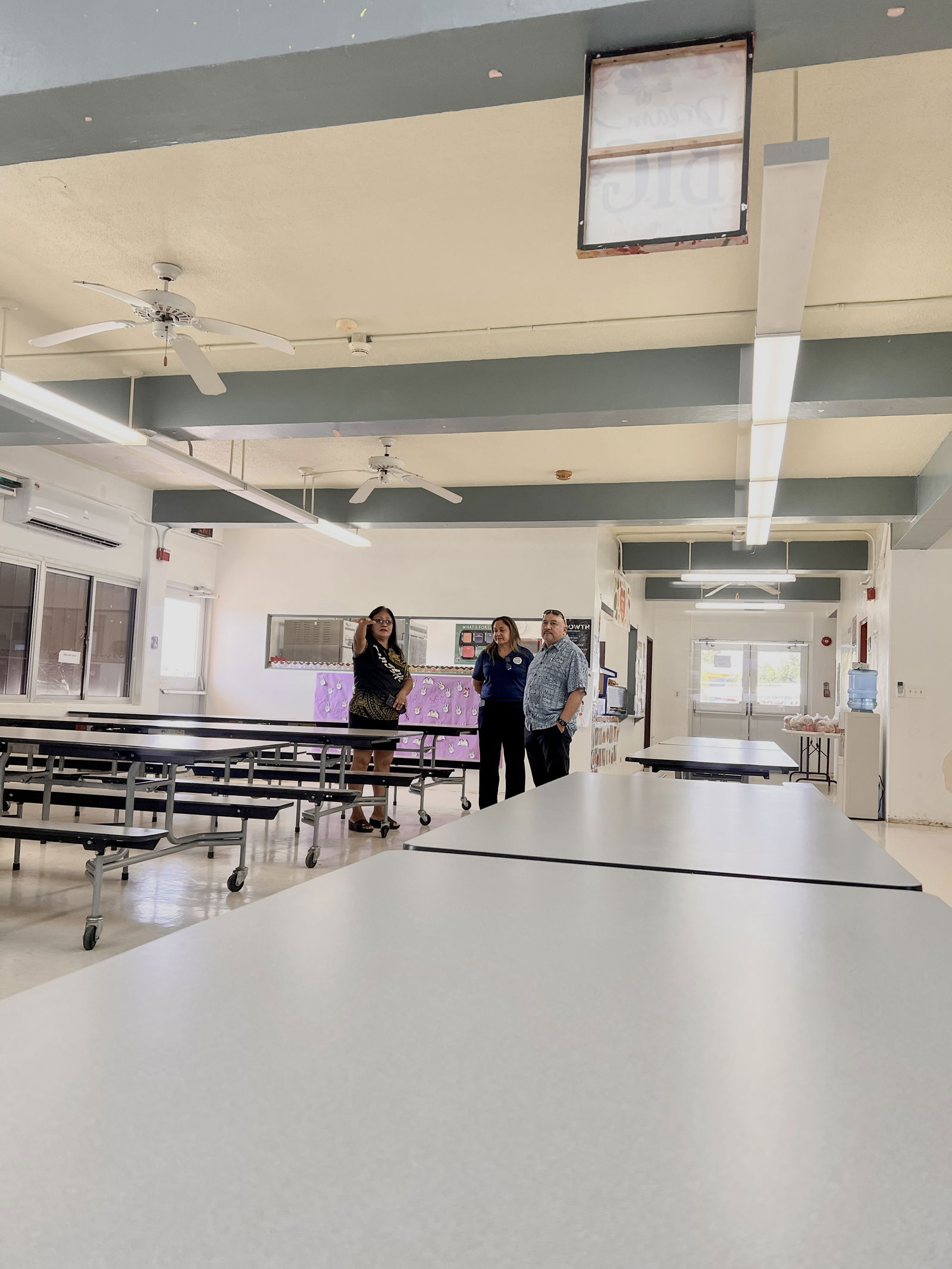 Dr. Rita Hocog Inos Junior-Senior High School Principal Annette Calvo, Commissioner of Education Dr. Lawrence Camacho, and Special Education Director Donna M. Flores in the school cafeteria.