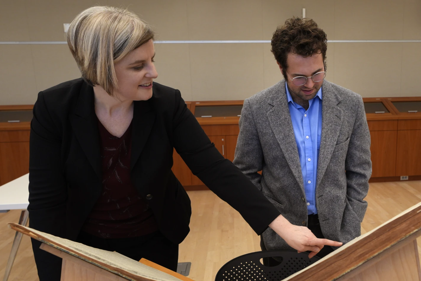 Max Chapnick, a postdoctoral teaching associate at Northeastern University, looks as Elizabeth Pope, curator of Books & Digital Collections, points out  a writing by “E.H. Gould” at the American Antiquarian Society, Tuesday, Jan. 9, 2024 in Worcester, Mass.