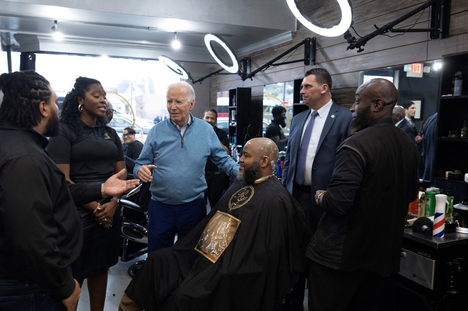 U.S. President Joe Biden greets a patron during an unannounced visit to Regal Lounge barber shop in Columbia, South Carolina, U.S., January 27, 2024. 