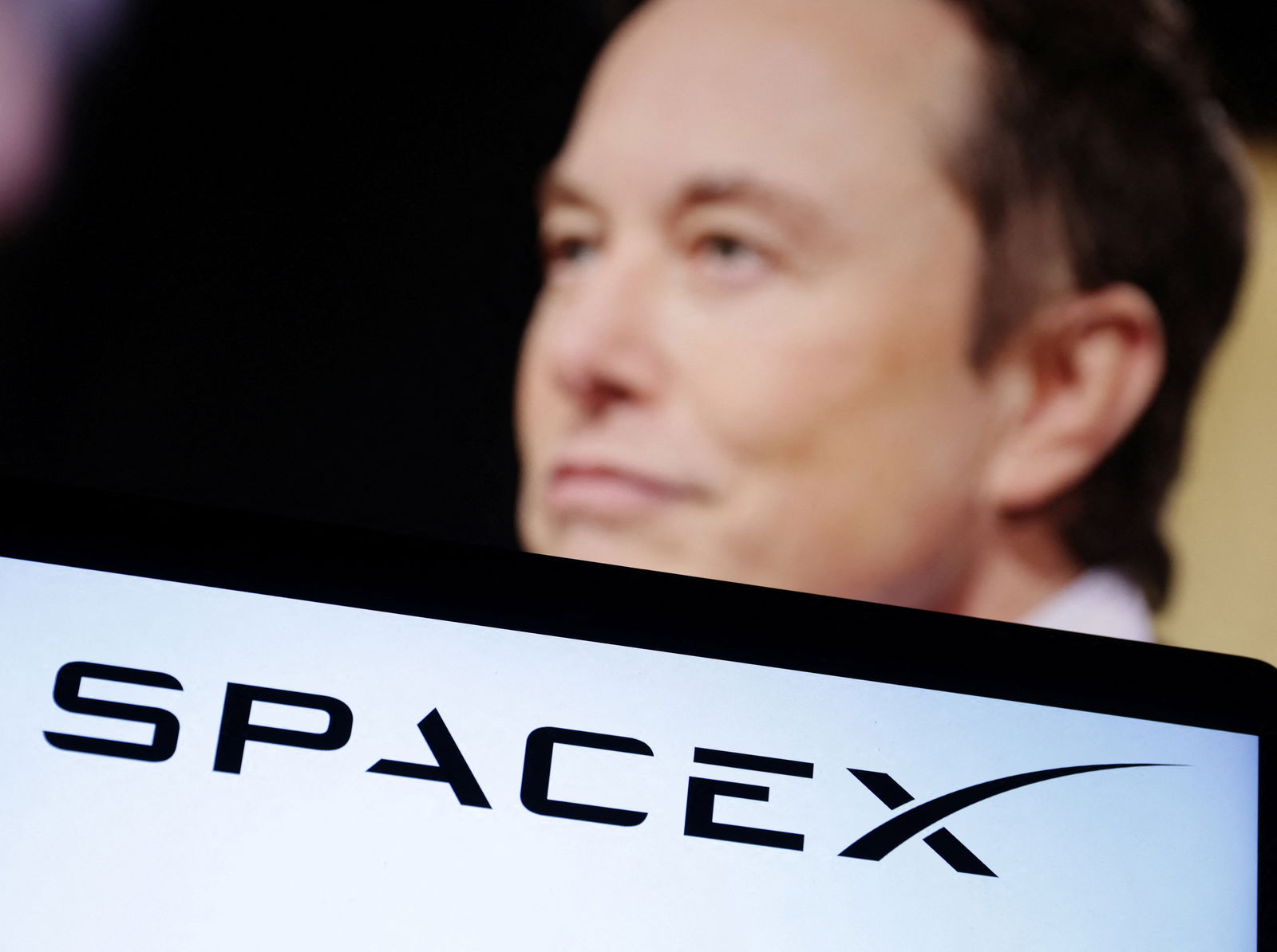 SpaceX logo and Elon Musk photo are seen in this illustration taken, December 19, 2022. 