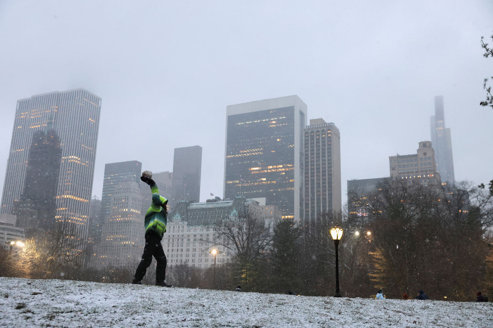 A person holds a snowball as snow falls in Central Park, New York City, U.S., January 6, 2024. 