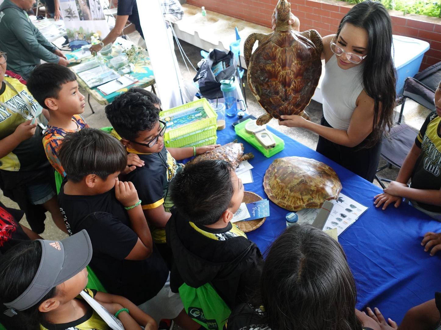 MY WAVE Club members learn about sea turtles from the Division of Fish & Wildlife at Garapan Central Park during the Marianas Tourism Education Council Tourism Summit on Jan. 19, 2024.