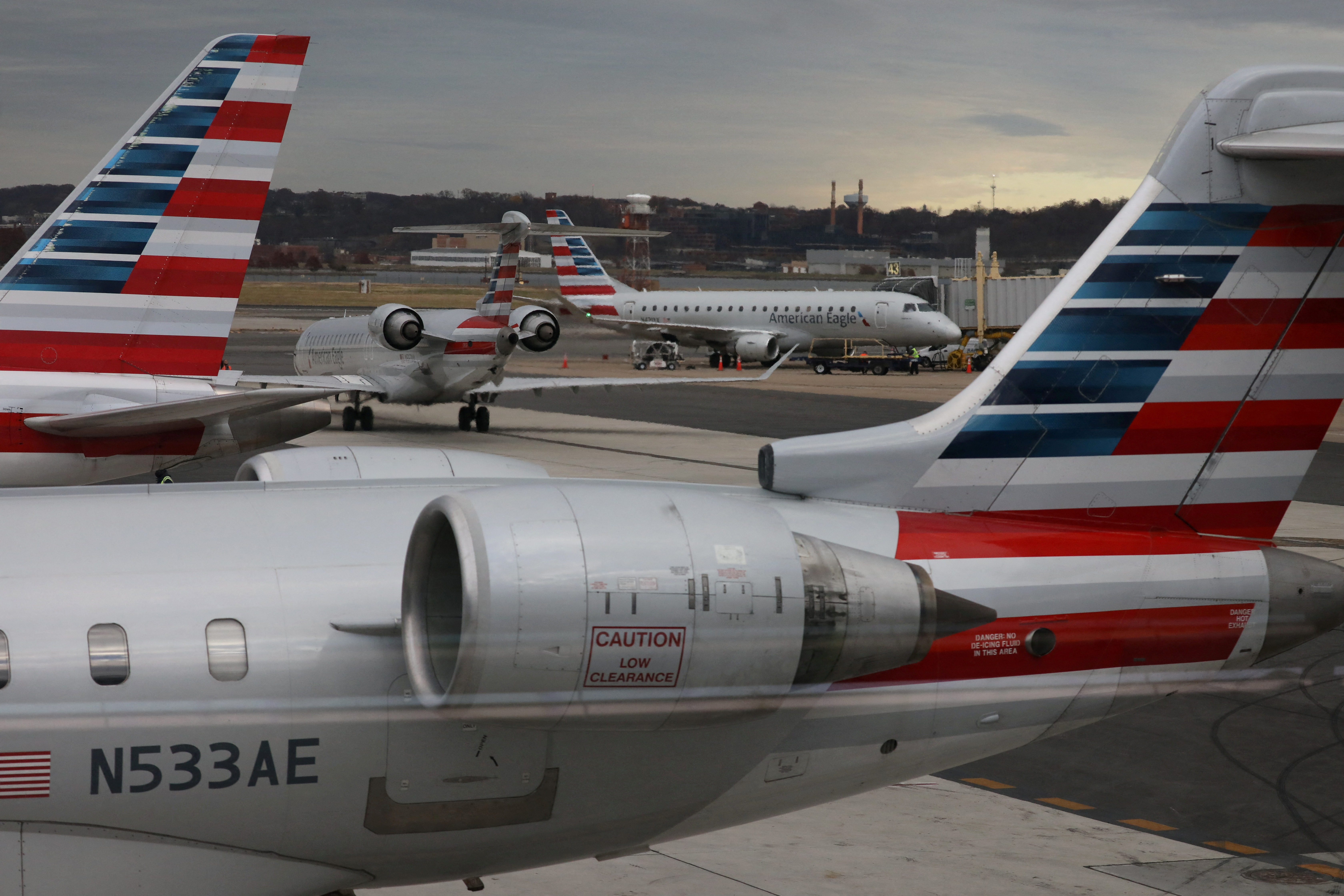 A jet from American Eagle, a regional branch of American Airlines (AA), taxis past other AA aircraft at Ronald Reagan Washington National Airport in Arlington, Virginia, U.S. December 3, 2021. 