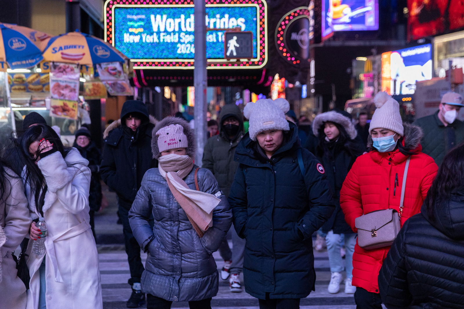 People walk in Times Square during cold weather in New York City, U.S., January 20, 2024. 