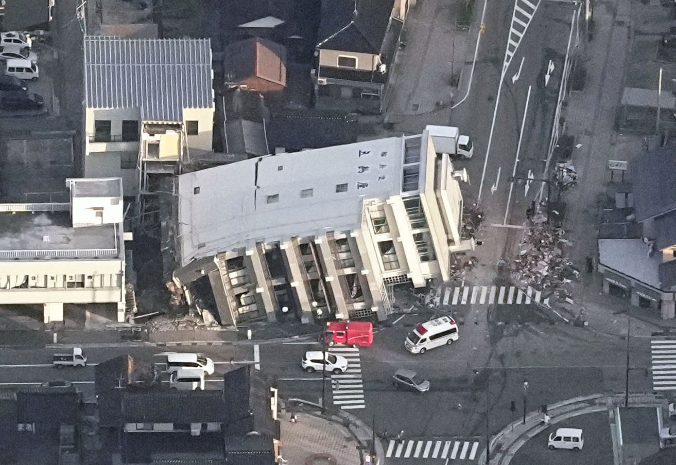 An aerial view shows a collapsed building caused by an earthquake in Wajima, Ishikawa prefecture, Japan January 2, 2024, in this photo released by Kyodo. 