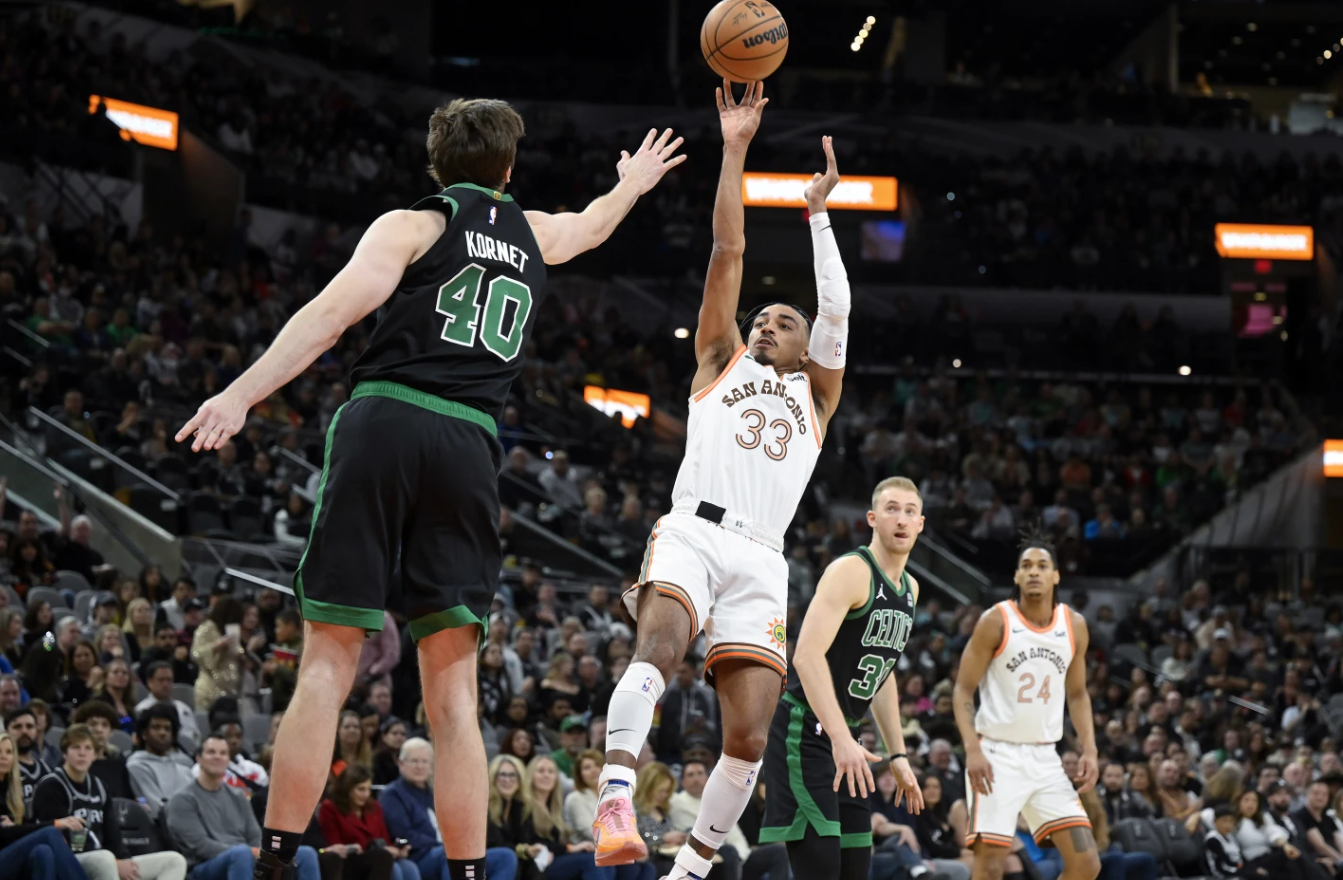 San Antonio Spurs’ Tre Jones (33) shoots against Boston Celtics’ Luke Kornet (40) during the first half of an NBA game, Sunday, Dec. 31, 2023 in San Antonio.