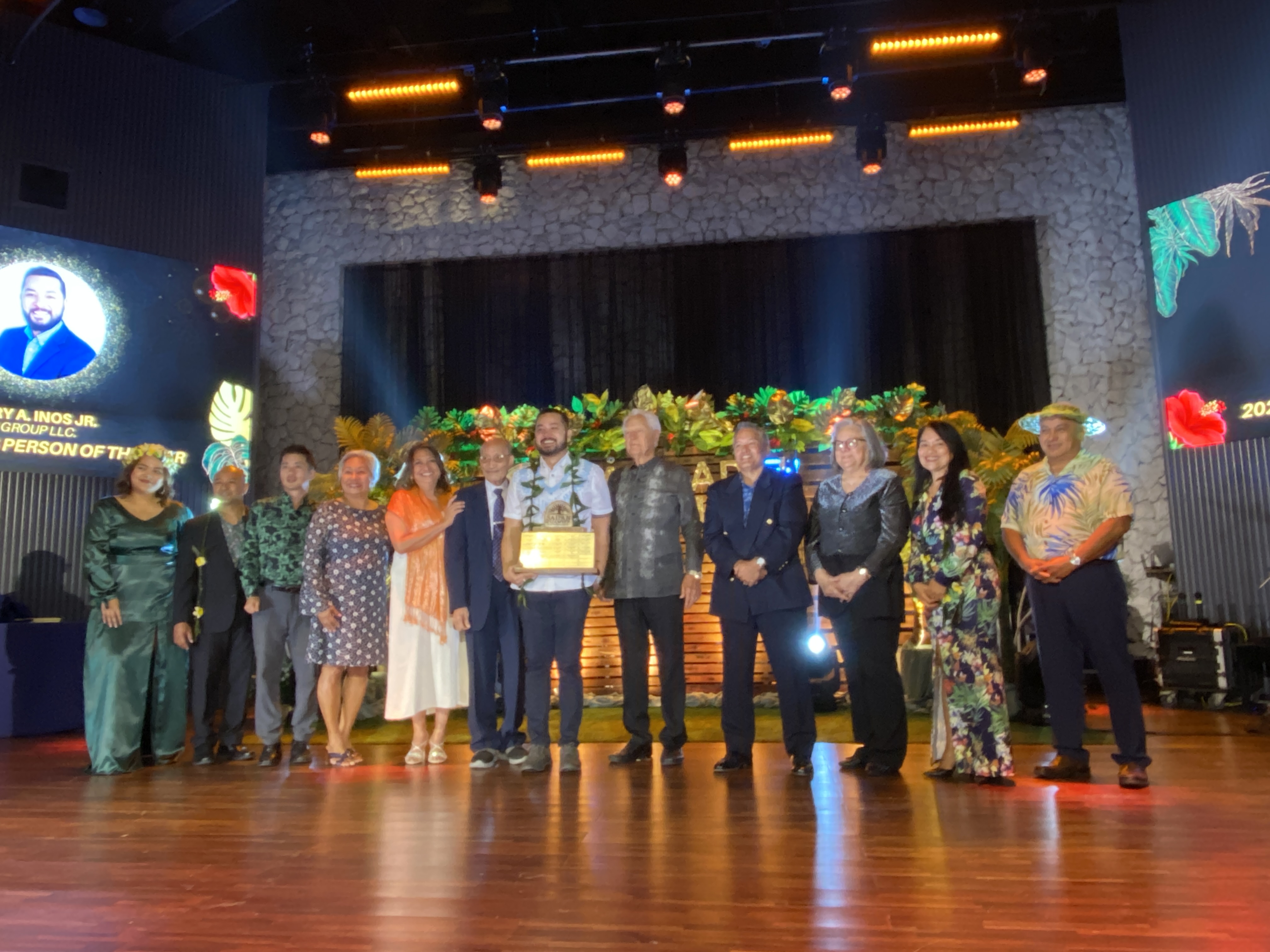 Perry Inos Jr. poses with some of the past winners of the Saipan Chamber of Commerce Business Person of the Year Award.