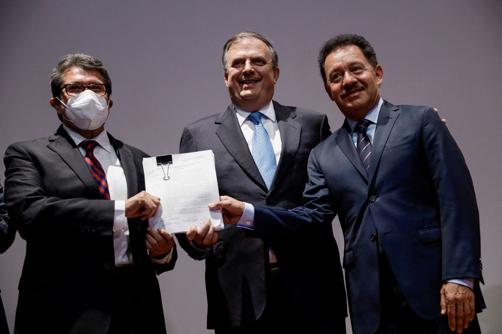 Mexican Foreign Minister Marcelo Ebrard, flanked by Senator Ricardo Monreal (L) and lawmaker Ignacio Mier (R), both of the Morena ruling party, pose for a photo during a news conference to announce that Mexico sued several gun makers in a U.S. federal court, accusing them of negligent business practices that generated illegal arms trafficking which led to deaths in Mexico, in Mexico City, Mexico August 4, 2021. 