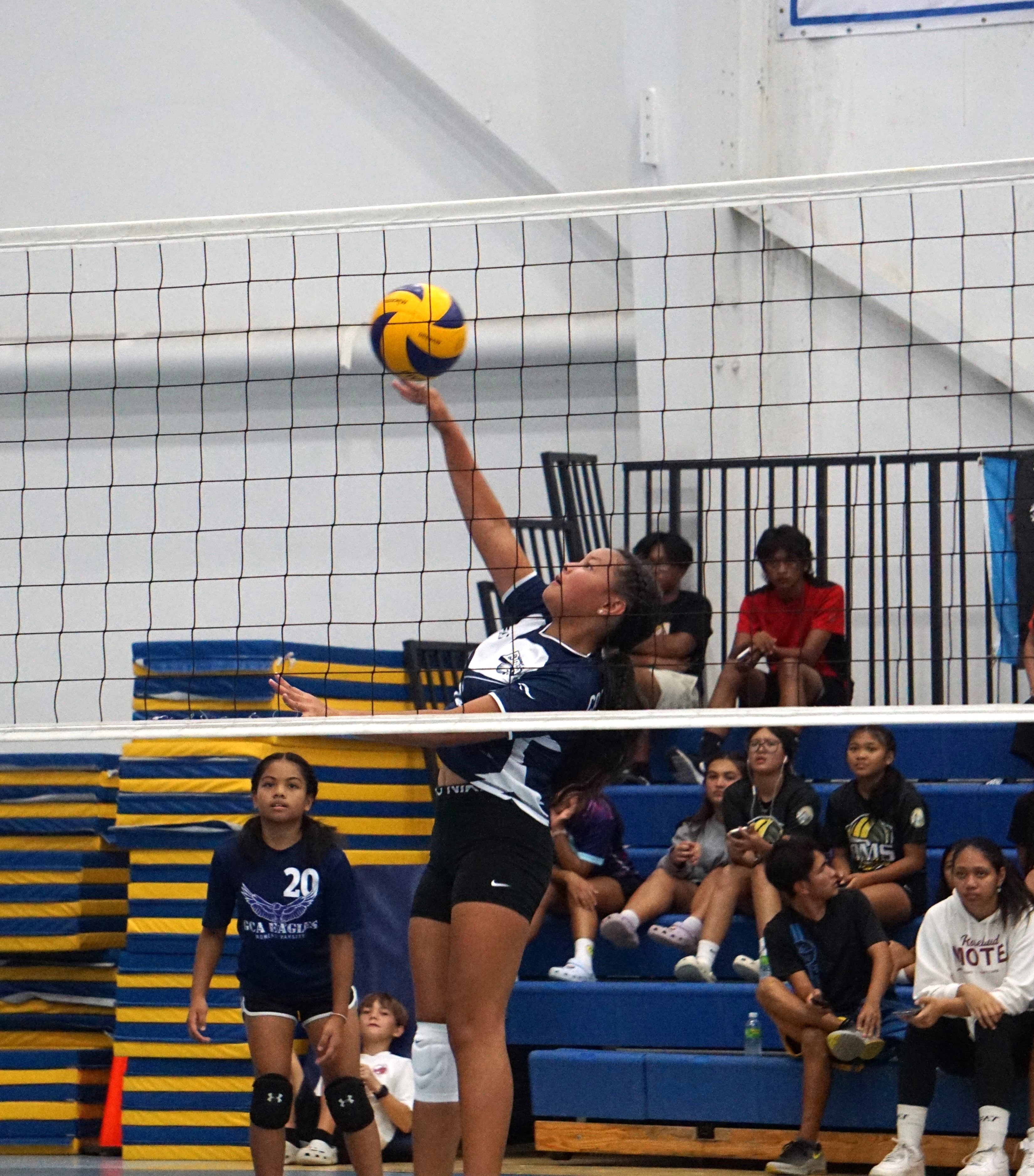 GCA's Neveah Camacho connects the spike return during  the girls middle school division title game of the NMIVA-PSS Interscholastic Volleyball League at the MHS gym.