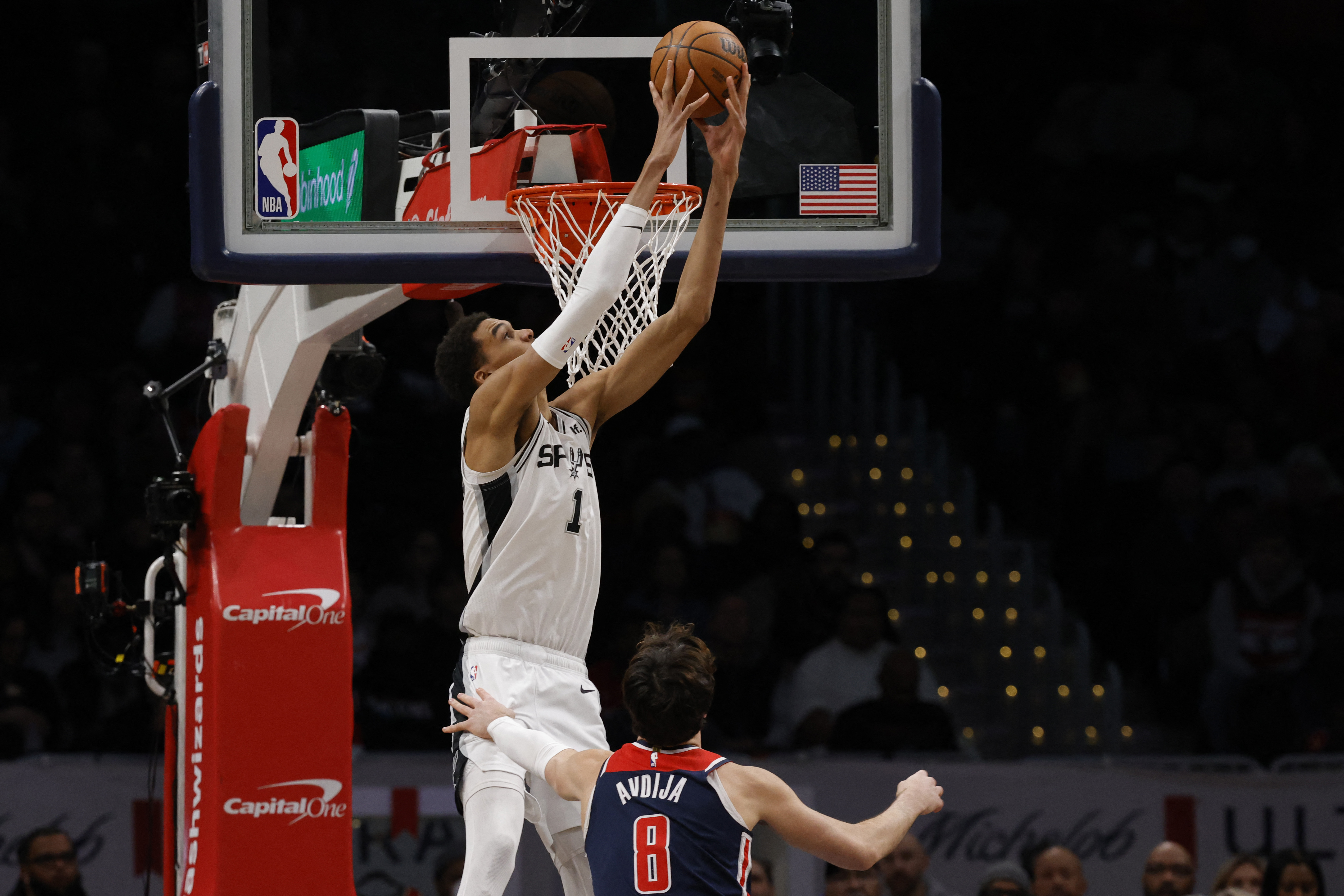 San Antonio Spurs center Victor Wembanyama (1) dunks the ball as Washington Wizards forward Deni Avdija (8) looks on in the first quarter at Capital One Arena in Washington, D.C., Jan. 20, 2024.