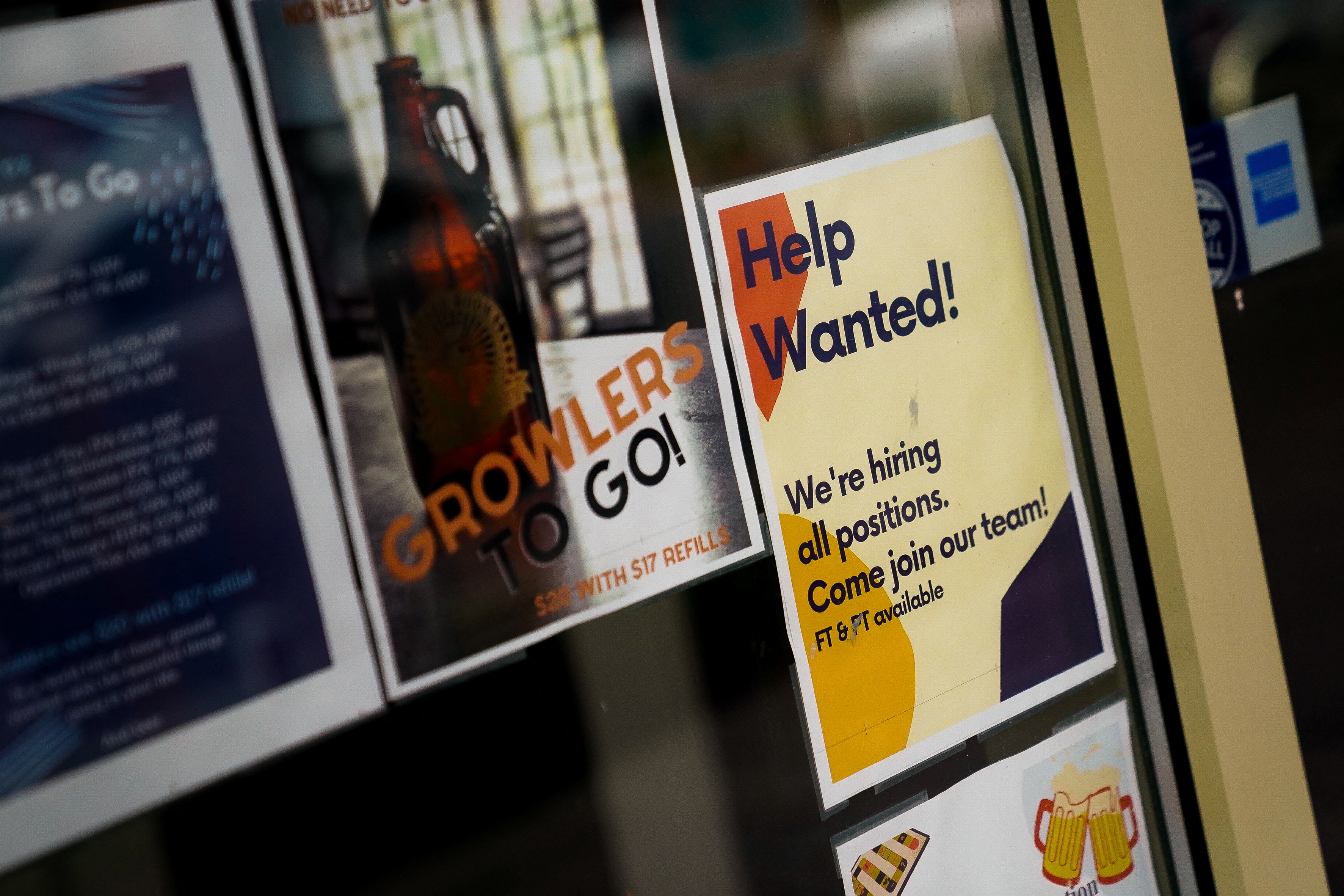 An employee hiring sign is seen in a window of a business in Arlington, Virginia, U.S., April 7, 2023. 