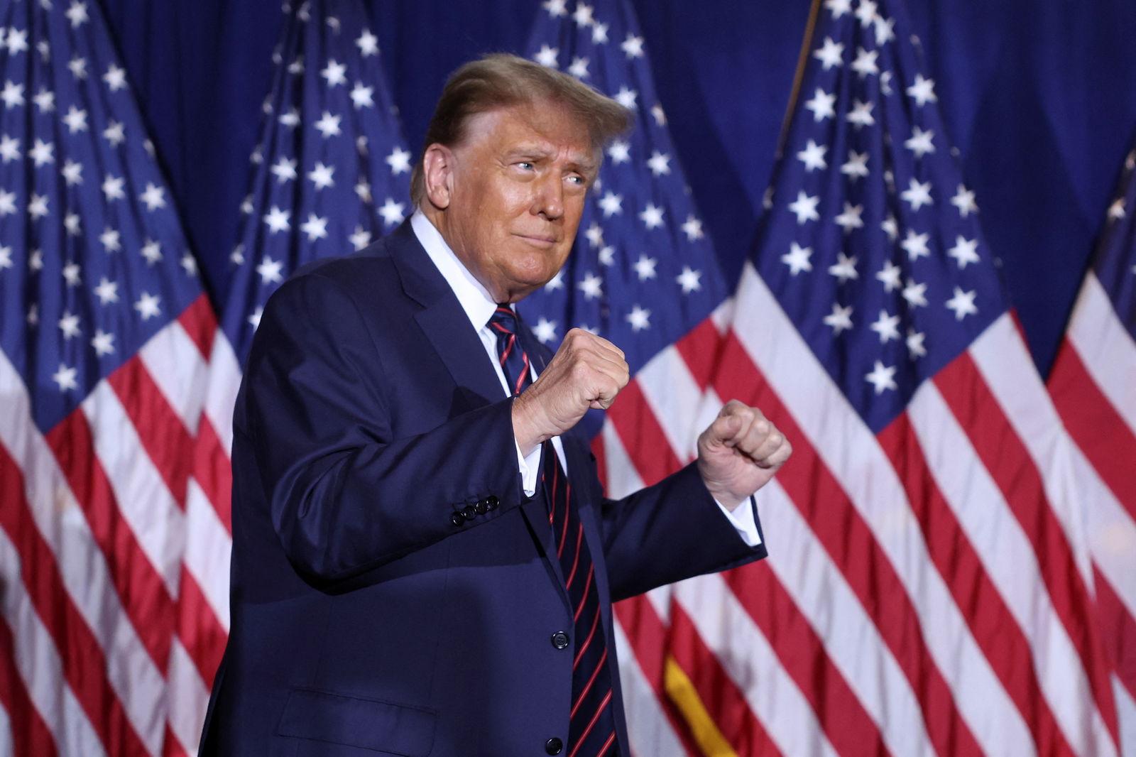 Republican presidential candidate and former U.S. President Donald Trump gestures as he takes the stage during his New Hampshire presidential primary election night watch party, in Nashua, New Hampshire, U.S., January 23, 2024. 