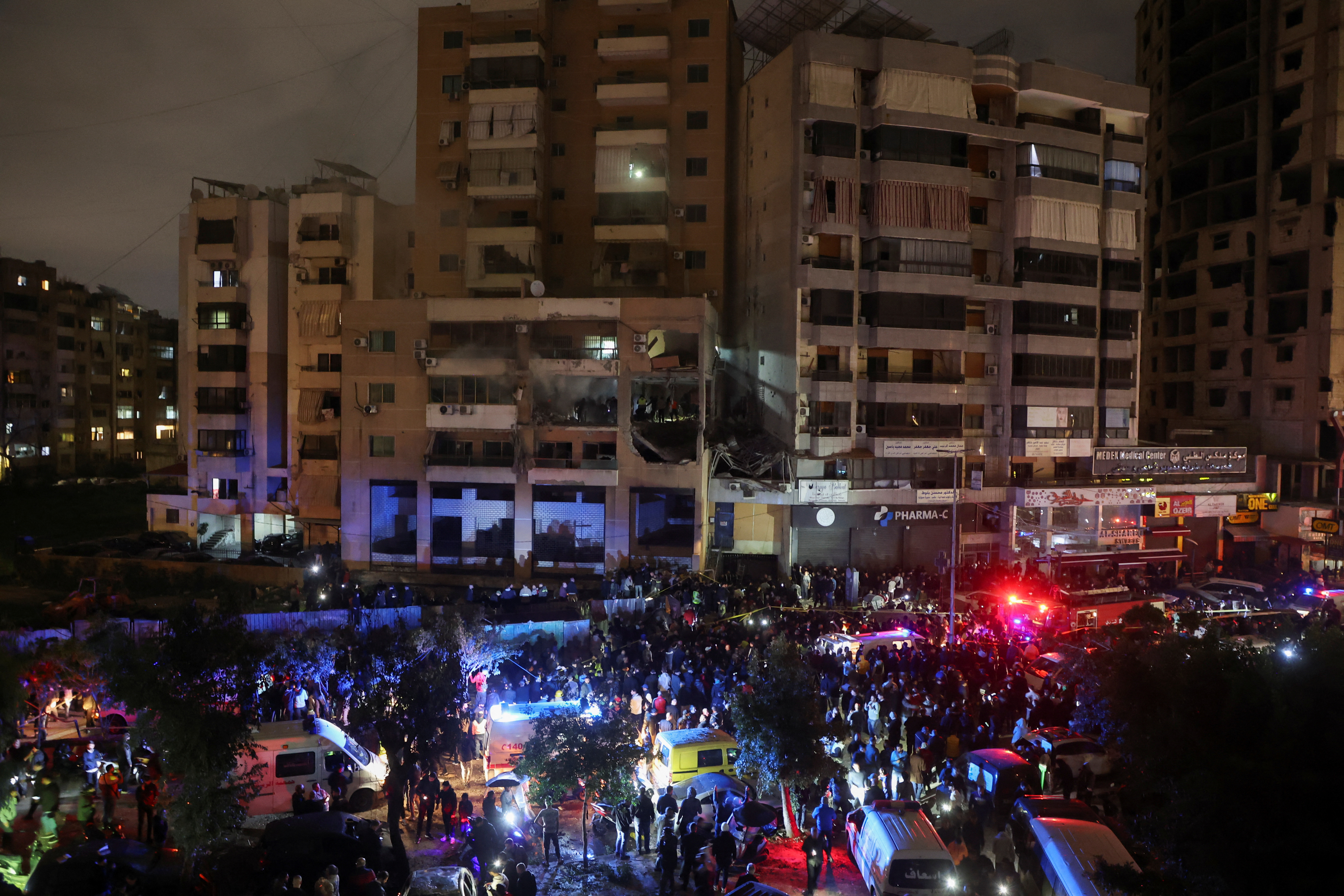 People gather near a damaged site following an explosion at the Beirut suburb of Dahiyeh, Lebanon January 2, 2024. 