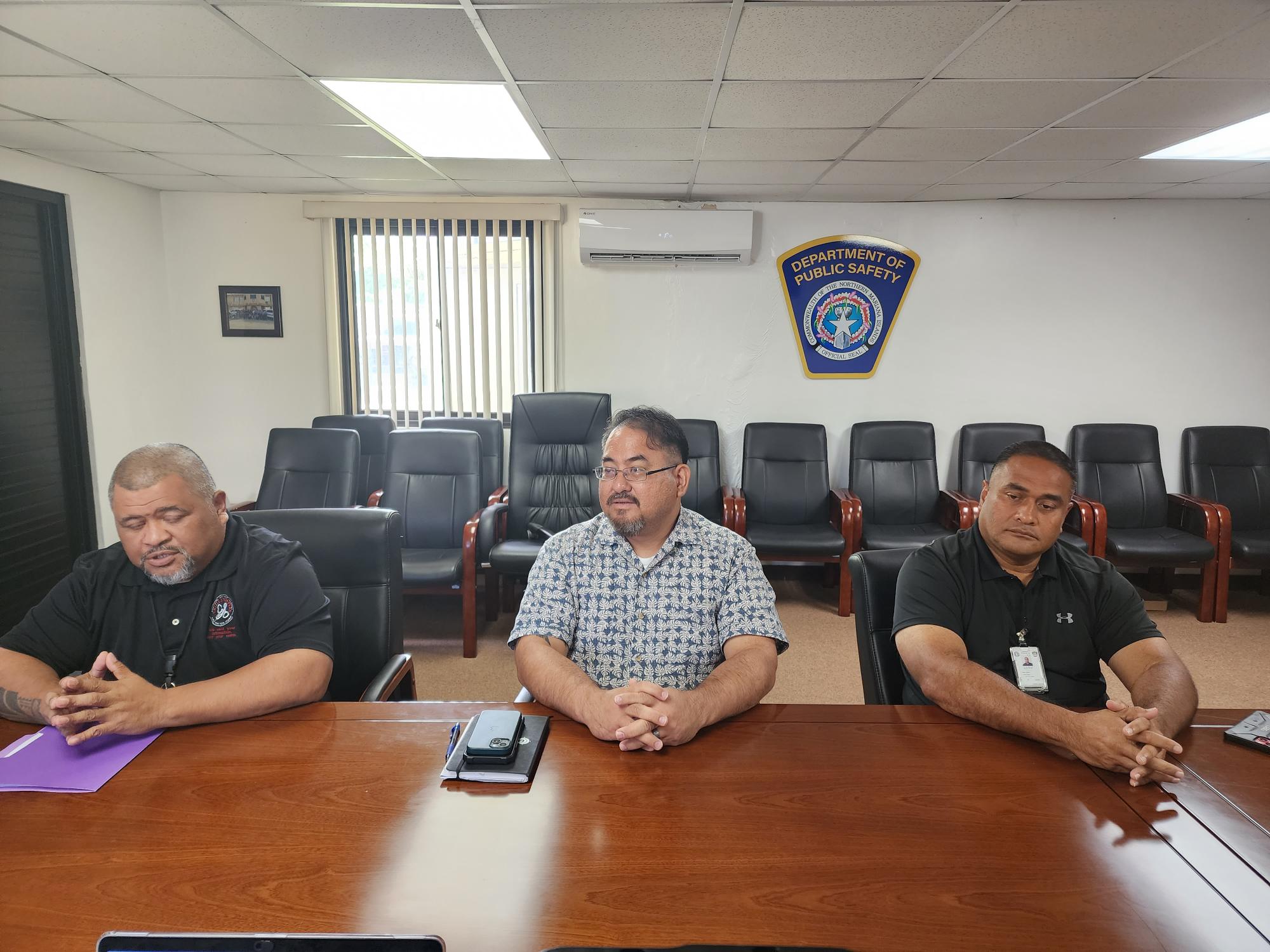 From left, Department of Public Safety public information officer Sgt. Fred Sato, DPS Commissioner Clement Bermudes, and Criminal Investigation Bureau Commander Captain Jeff Olopai conduct a press conference, Tuesday.