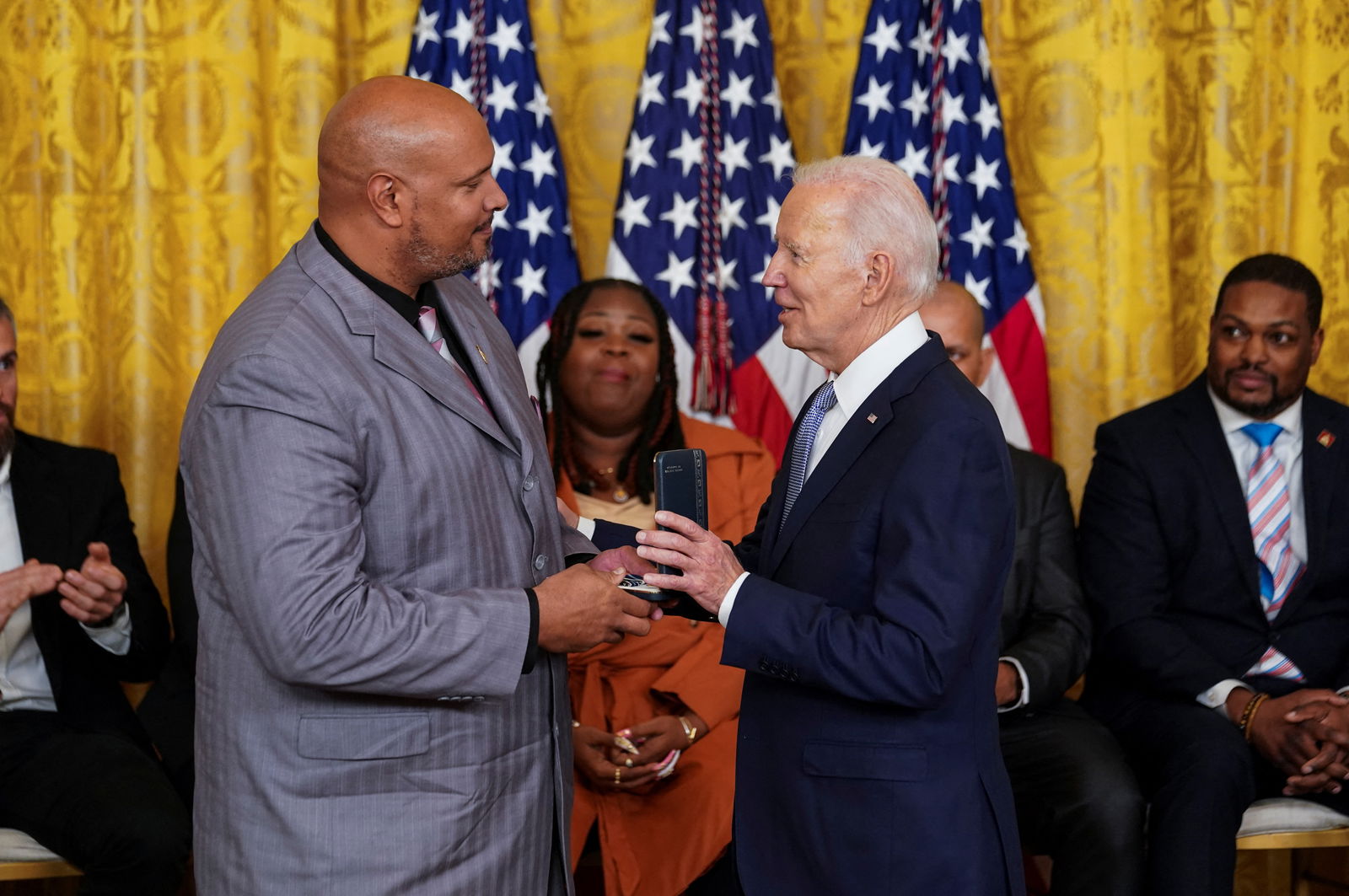 U.S. President Joe Biden presents a Presidential Citizens Medal to U.S. Capitol Police Officer Harry Dunn during a ceremony marking two years since the January 6, 2021, attack on U.S. Capitol, in the East Room at the White House in Washington, U.S., January 6, 2023. 