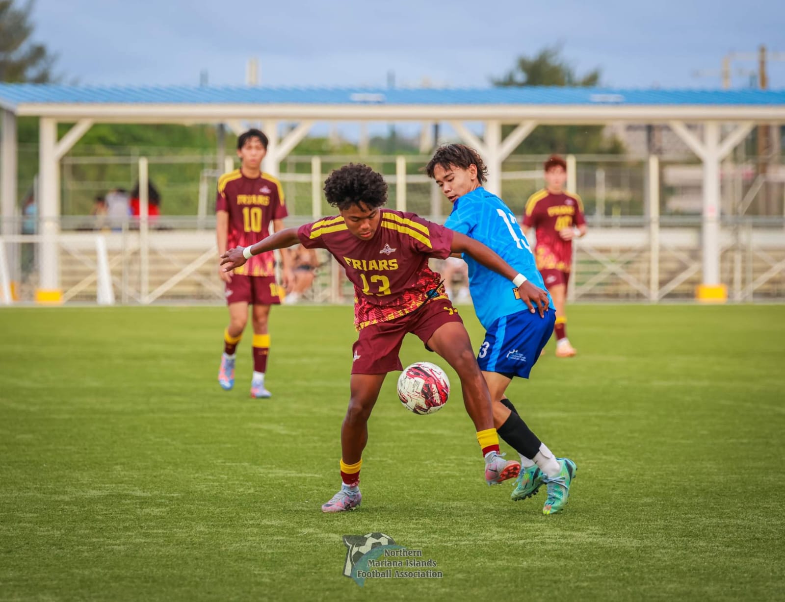 Marianas High School’s Wataru Kadokura battles for the possession against Donovan Moss of Father Duenas Memorial School during a friendly match at the NMI Soccer Training Center in Koblerville on Wednesday.