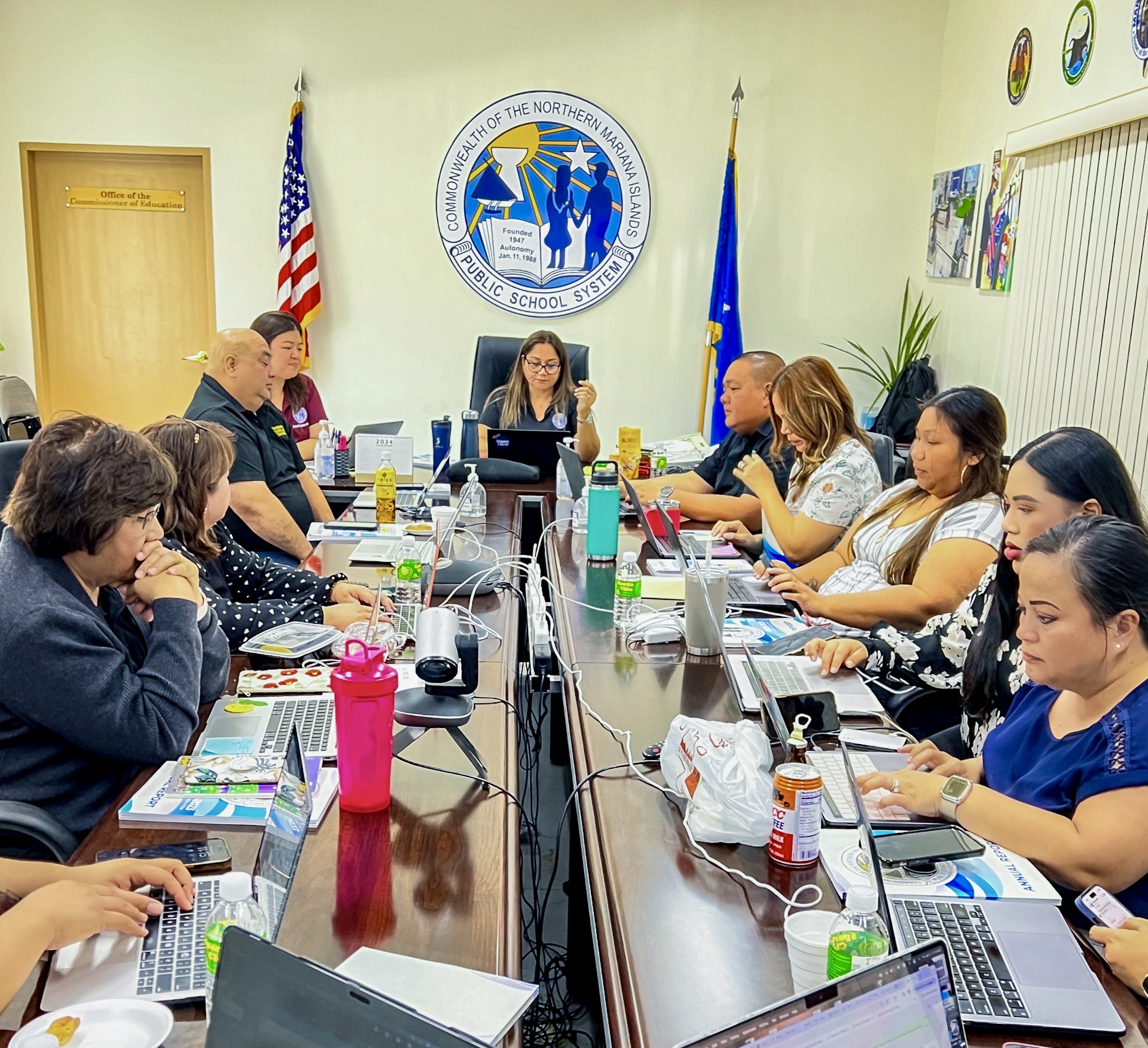 Donna M. Flores, center, background, the special program director of the Public School System, served as acting education commissioner for four months. Photo shows her presiding over a meeting with other PSS managers on Friday.