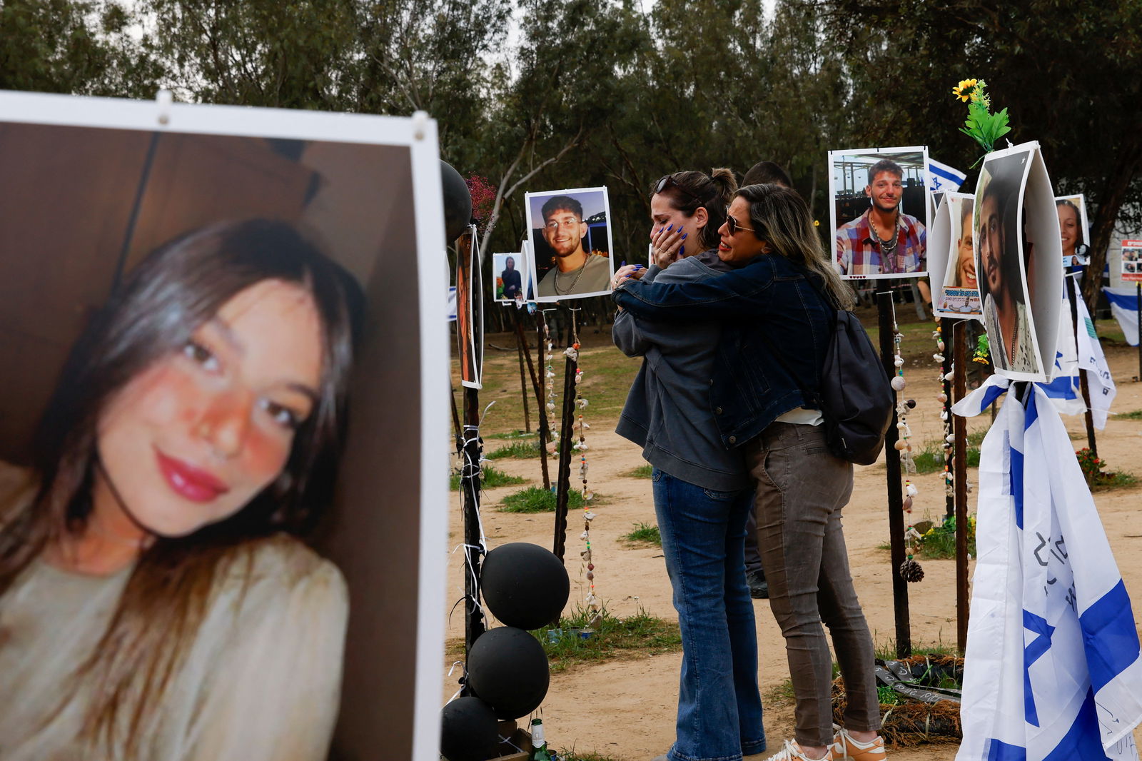 People react as family members and relatives visit the site of the Nova festival, where people were killed and kidnapped during the October 7 attack by Hamas gunmen from Gaza, amid the ongoing conflict between Israel and the Palestinian Islamist group Hamas, in Reim, southern Israel, January 21, 2024. 