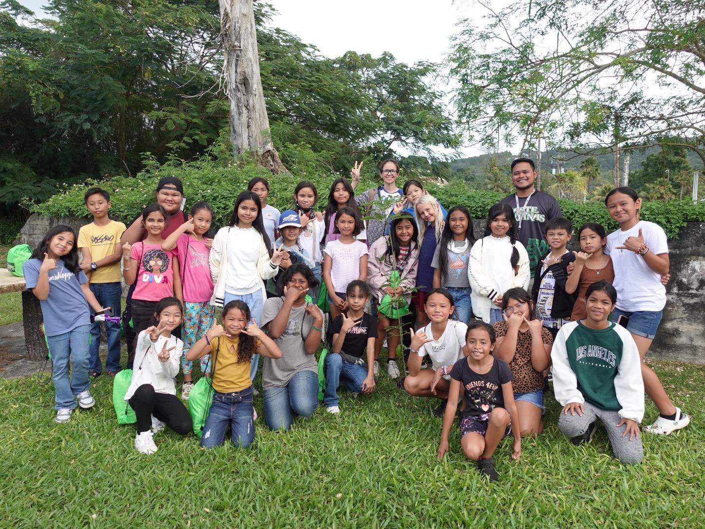 Marianas Visitors Authority Community Projects Specialist Jack Aranda, back right, leads MY WAVE Club students and chaperones of Garapan Elementary School in a tree planting activity at Garapan Central Park during the Marianas Tourism Education Council on Jan. 19, 2024.  In all, clubs planted 10 trees at Garapan Central Park and Sugar King Park.