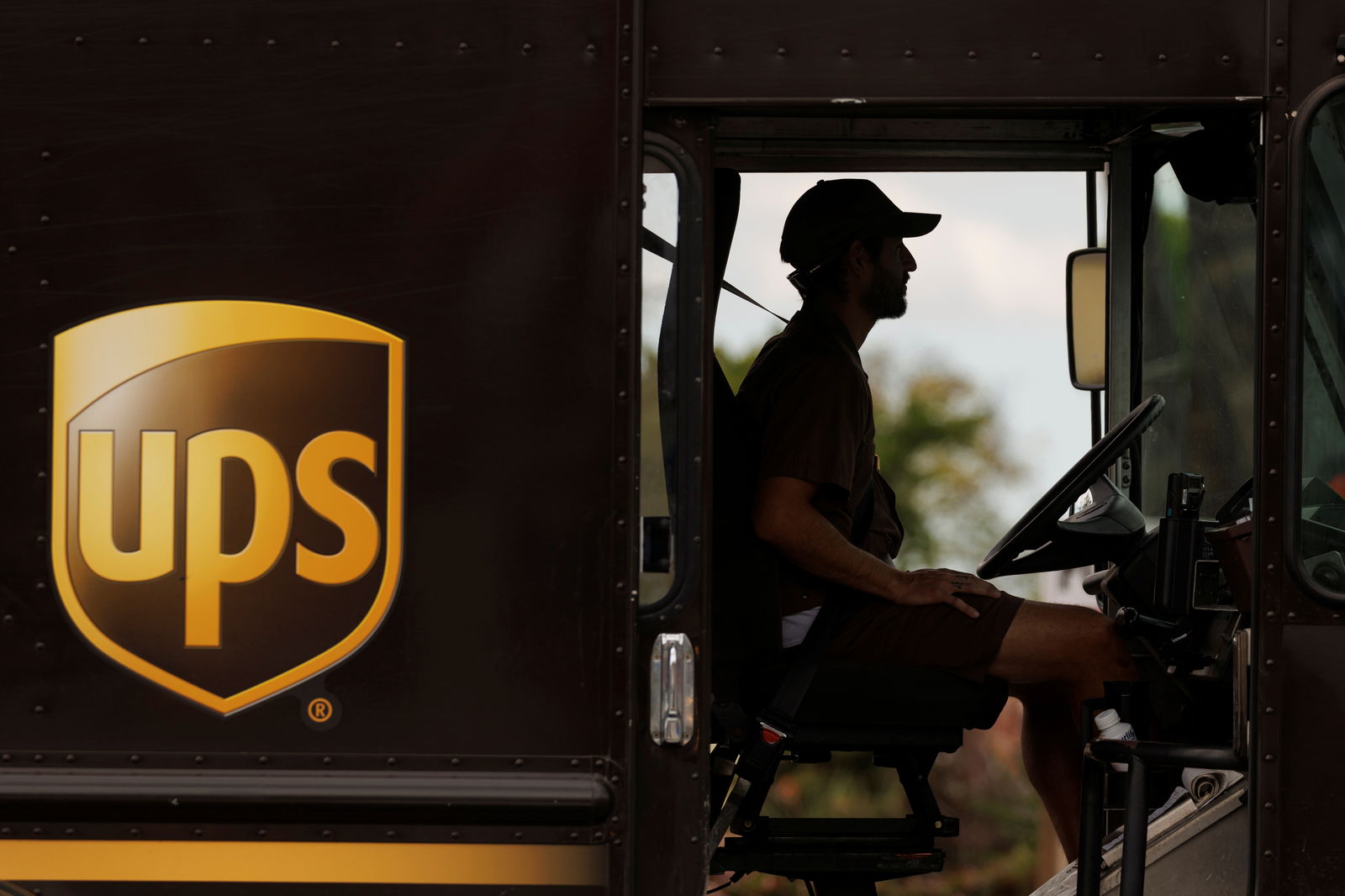 A UPS delivery van is driven long a city street in Garden Grove, California, U.S., March 29, 2022. 