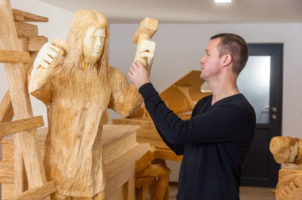 Tomislav Horvat inspects a new sculpture of Michelangelo made of matches in Domasinec, Croatia, Jan. 17, 2024.