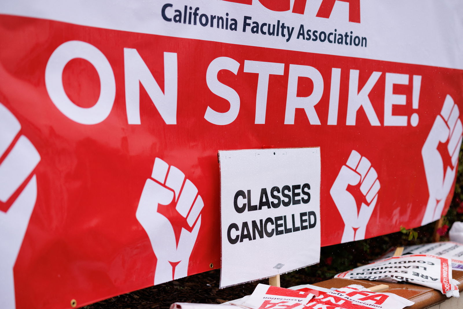 Signs are displayed while picketing begins at San Diego State University as the California Faculty Association, the union representing 29,000 professors, lecturers, librarians, counselors and coaches across the California State University start a planned five-day strike in San Diego, California, U.S. January 22, 2024. 