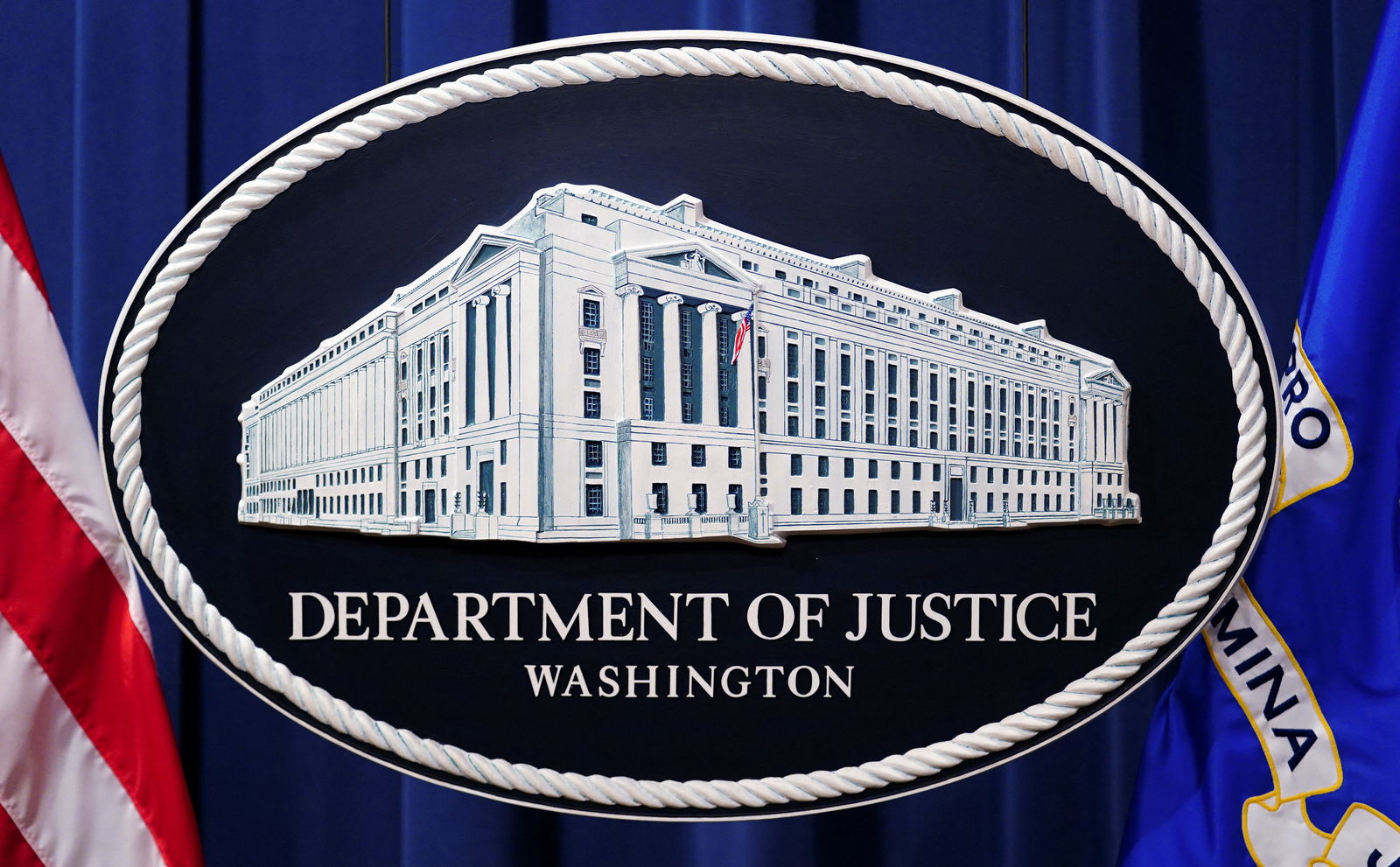 A U.S. Justice Department logo or seal showing Justice Department headquarters is seen behind the podium in the Department's headquarters briefing room before a news conference with the Attorney General in Washington, January 24, 2023. 