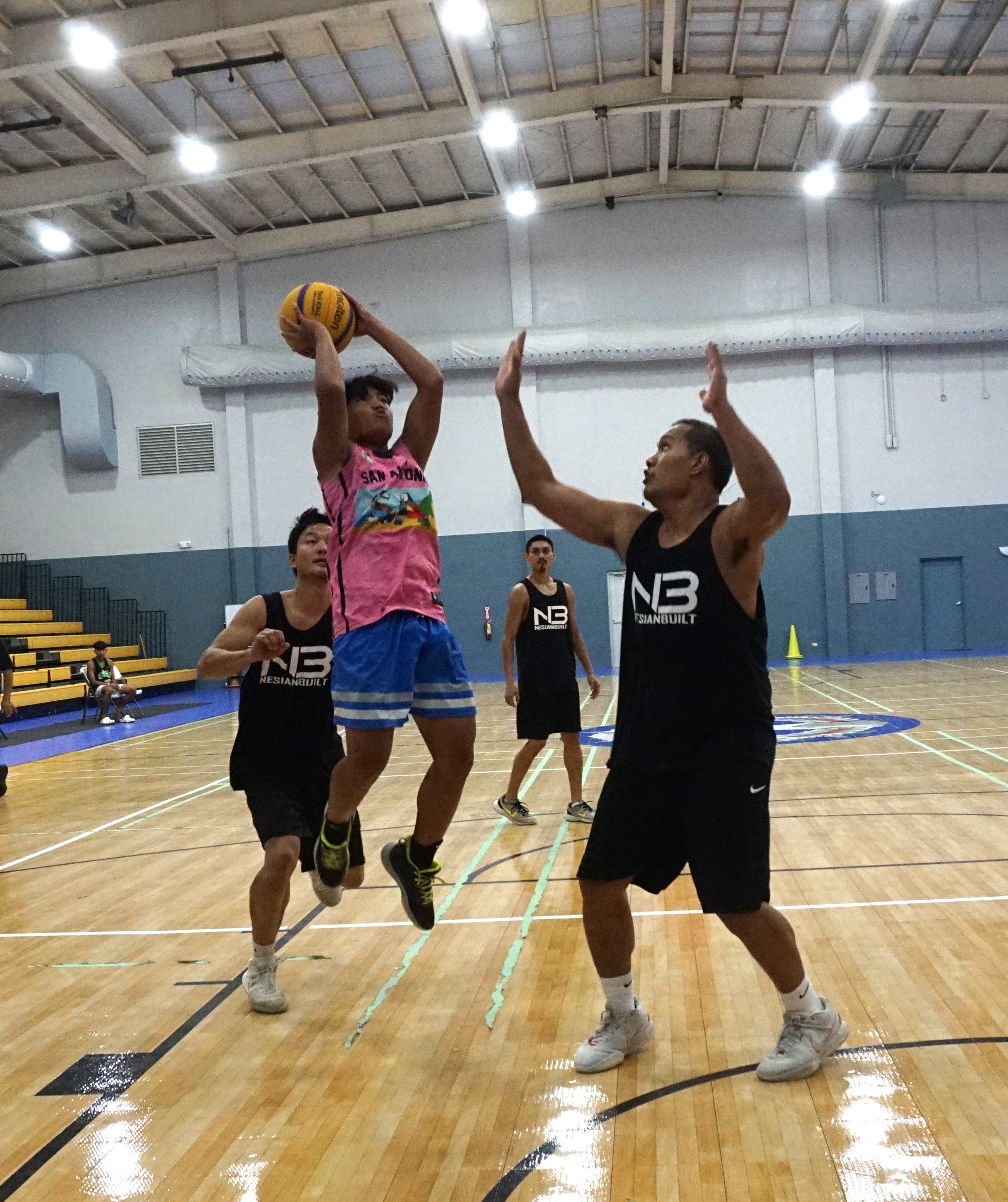 Shots Fired's Jezpher Navarro pulls up for the midrange shot over Team Nesian Built's Jack Lizama during the finale of the third tournament of the Marianas Arsenal 3x3 Series at the Ada gym on Saturday.