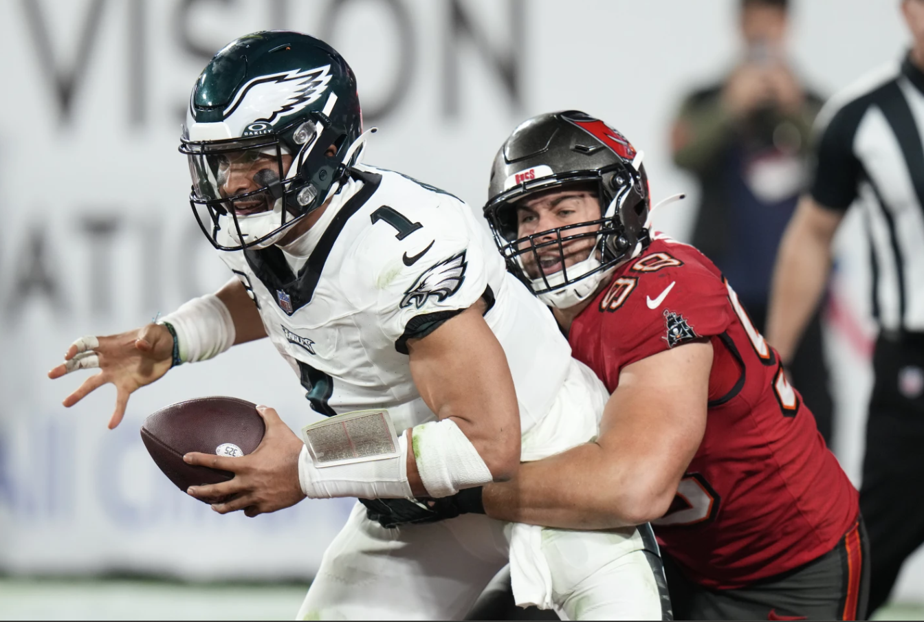 Philadelphia Eagles quarterback Jalen Hurts is sacked for a safety in the end zone by Tampa Bay Buccaneers linebacker Anthony Nelson during the second half of an NFL wild-card playoff game, Monday, Jan. 15, 2024 in Tampa, Fla.