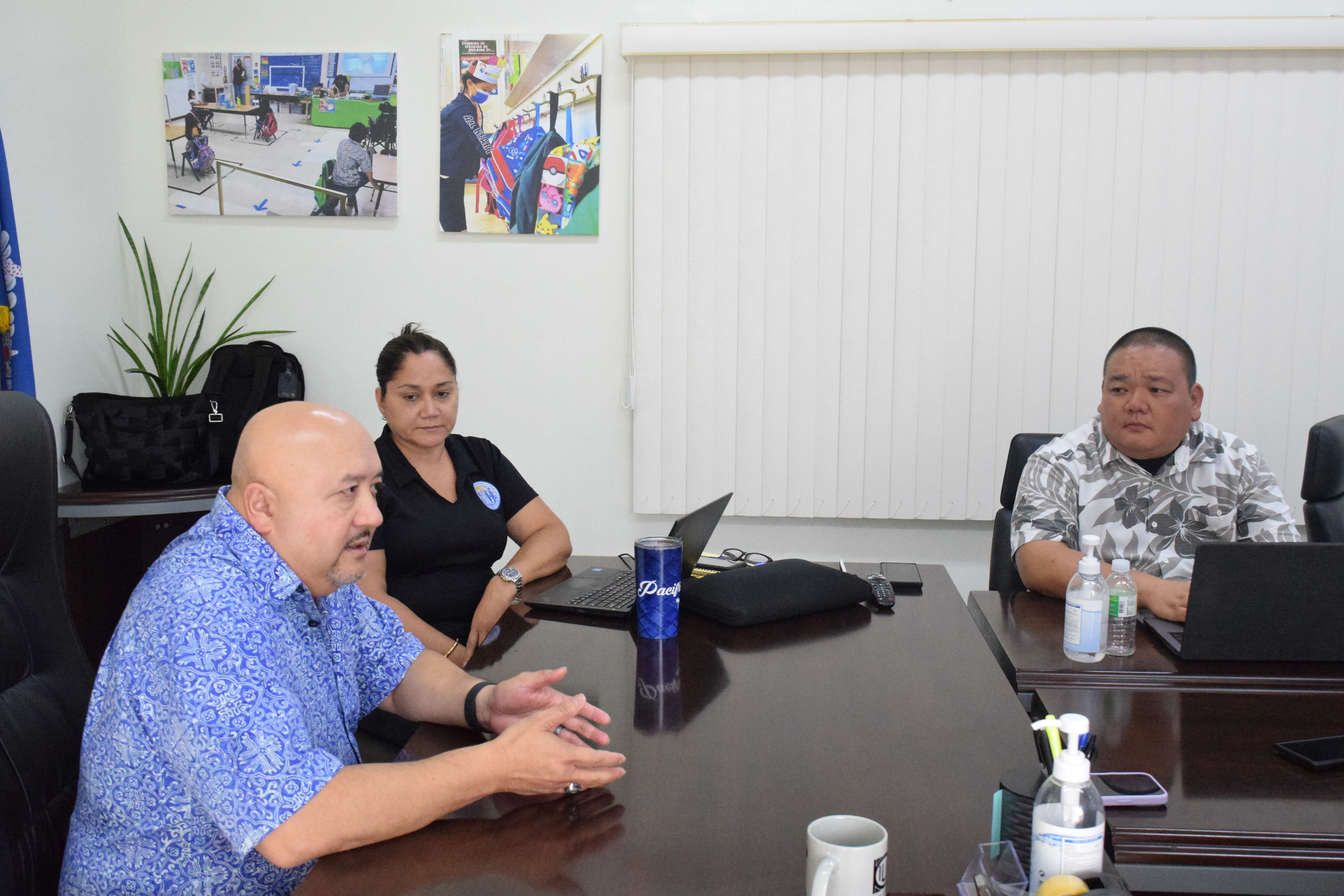 Education Commissioner Dr. Lawrence F. Camacho, left, speaks to reporters as Special Education Program Director Donna Flores and Associate Commissioner for Administration Eric Magofna look on during a get-to-know meeting in the commissioner's conference room on Tuesday.