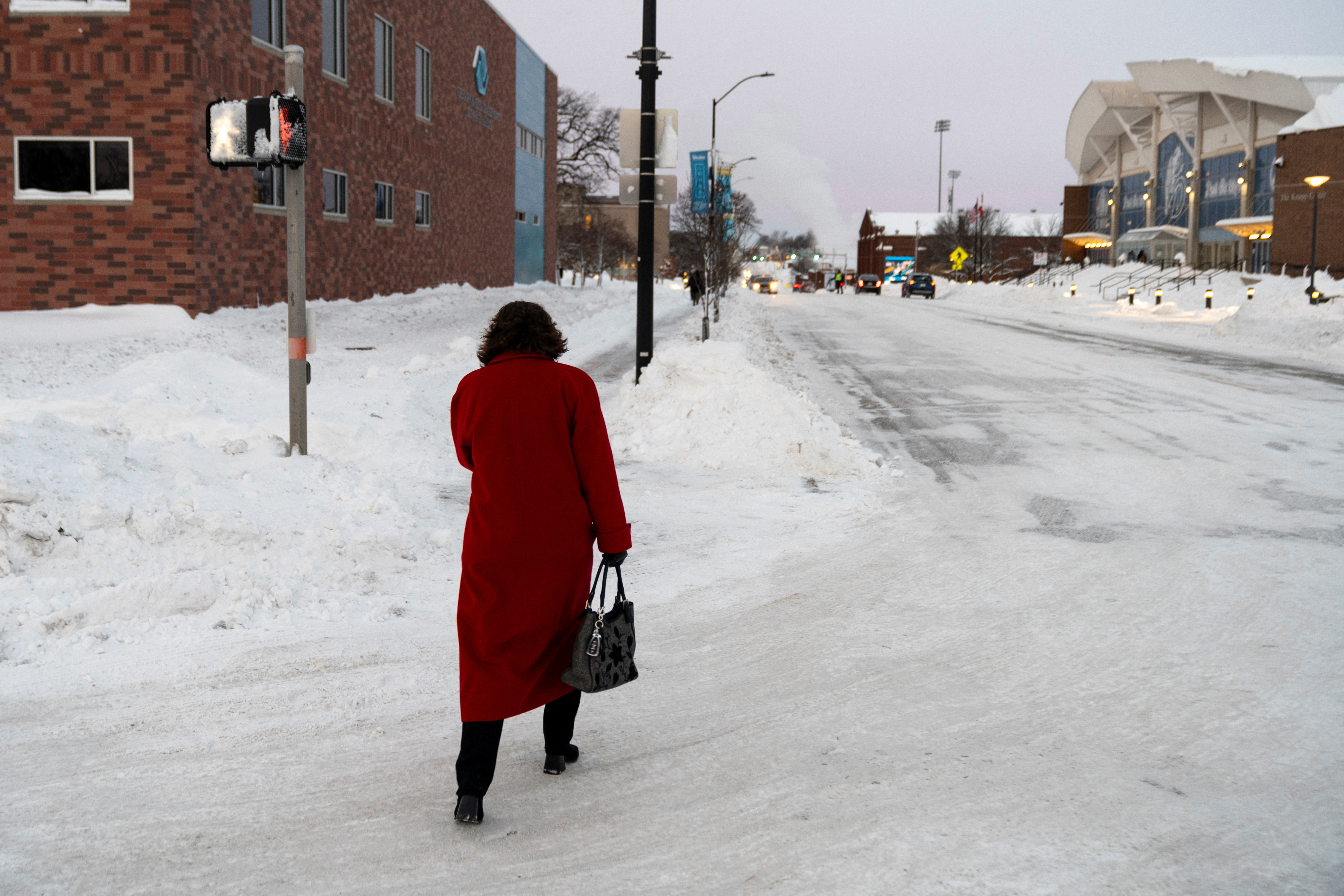 A woman walks down a street amid sub-zero temperatures, ahead of the Iowa state caucus vote, in Des Moines, Iowa, U.S., January 15, 2024. 