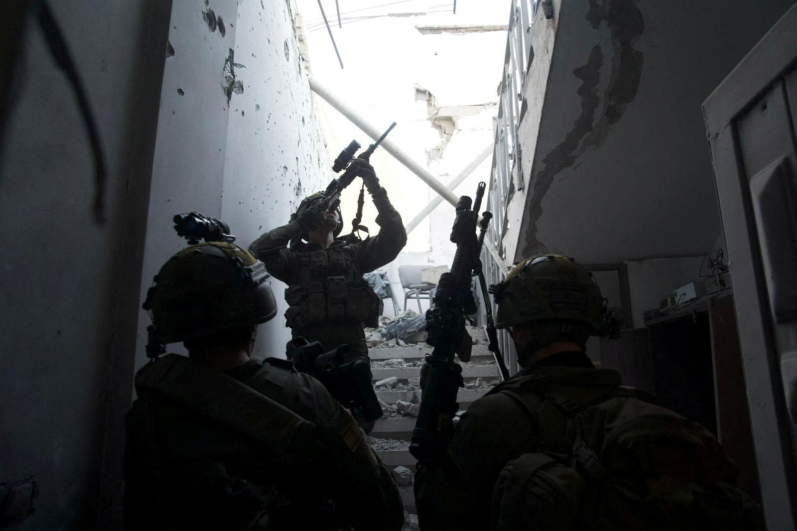 Israeli soldiers take part in a ground operation, amid the ongoing conflict between Israel and the Palestinian Islamist group Hamas, in a location given as Gaza Strip, in this handout picture released on January 19, 2024. 
