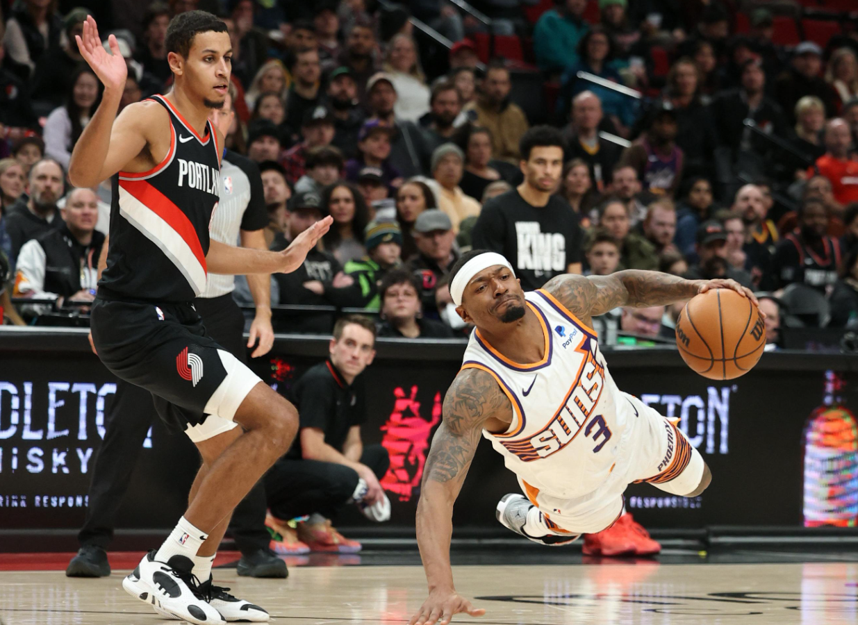 Phoenix Suns guard Bradley Beal (3) falls to the floor after being fouled by Portland Trail Blazers forward Kris Murray (8) in the fourth quarter at Moda Center in Portland, Oregon, Jan. 14, 2024.