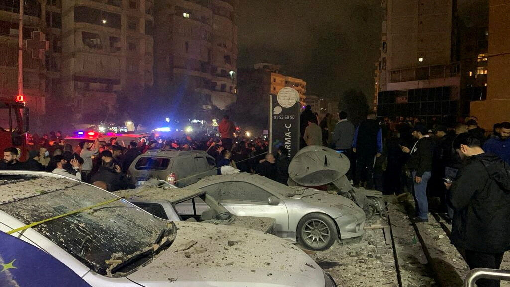 People gather near a damaged site following an explosion, in what security sources say is an Israeli drone strike, at the Beirut suburb of Dahiyeh, Lebanon January 2, 2024. 