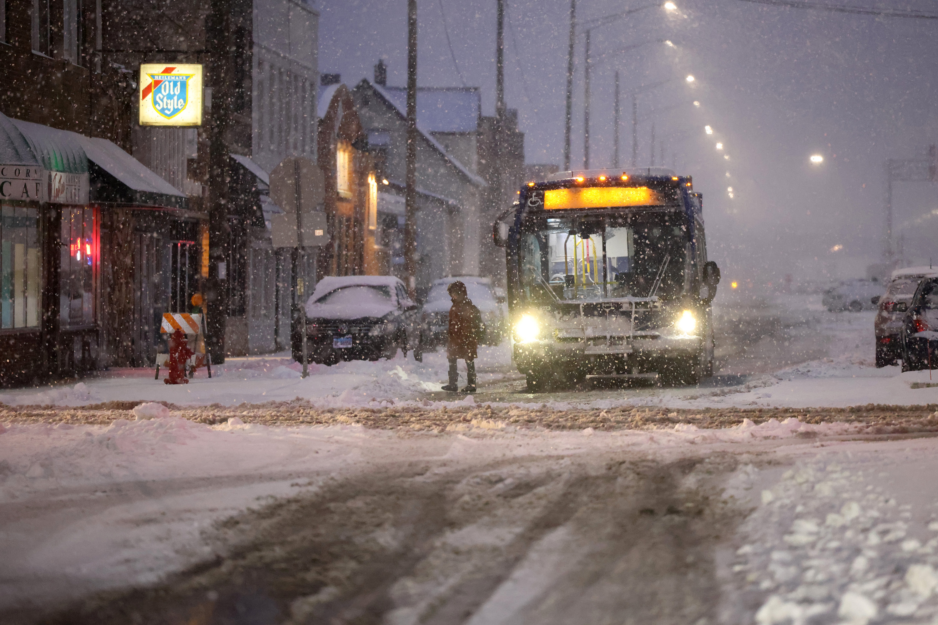 A bus drops off a commuter near the Berwyn Metra stop as a winter storm hits the Chicago area on Friday, Jan. 12, 2024.