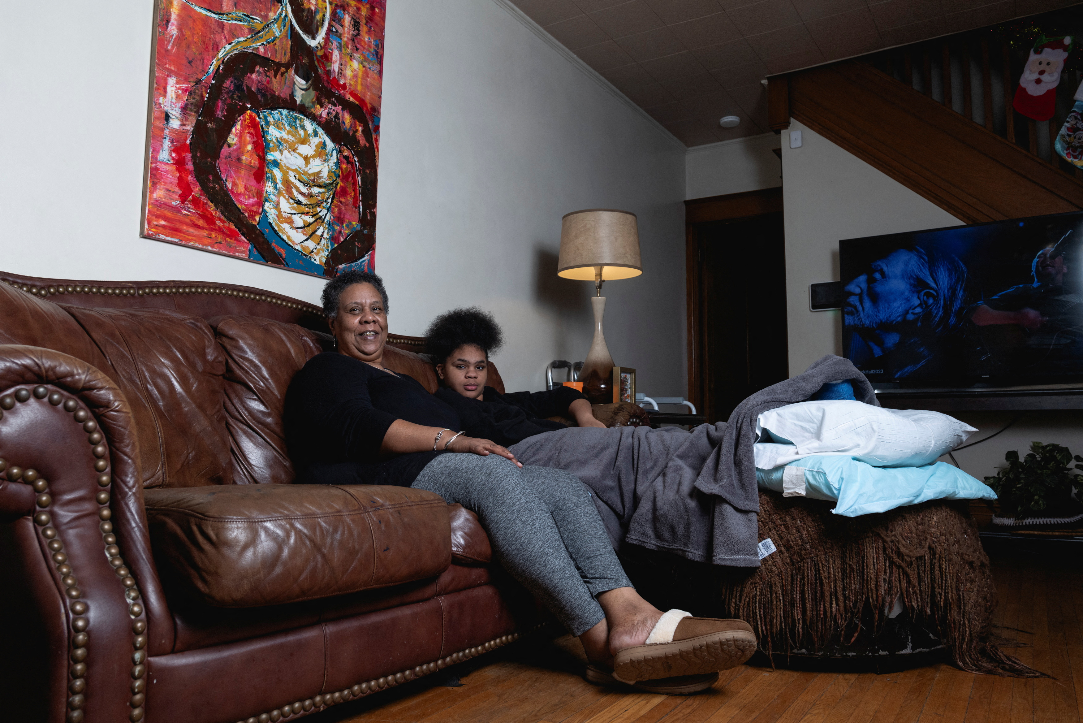 Charla Plaines, a 66-year-old grandmother, poses for a photo with her 11-year-old granddaughter, Loyalty Johnson, in her home in Harrisburg, Pennsylvania, U.S., December 28, 2023. 