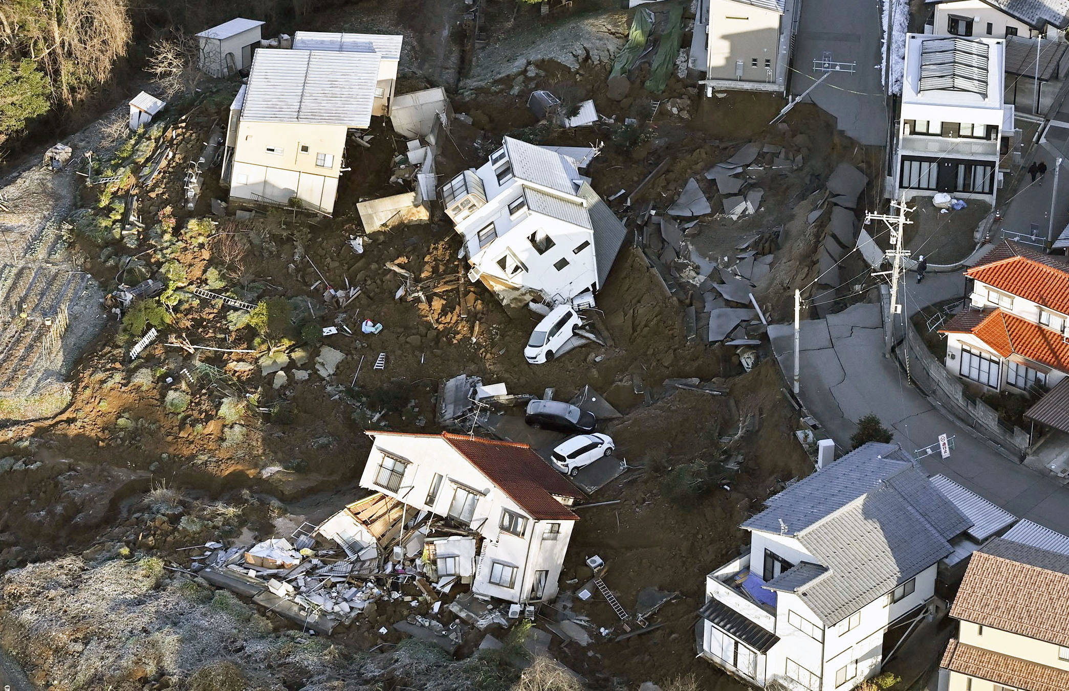 An aerial view shows collapsed houses, cars and roads caused by an earthquake in Kanazawa, Ishikawa prefecture, Japan January 2, 2024, in this photo released by Kyodo. Mandatory credit Kyodo/via REUTERS