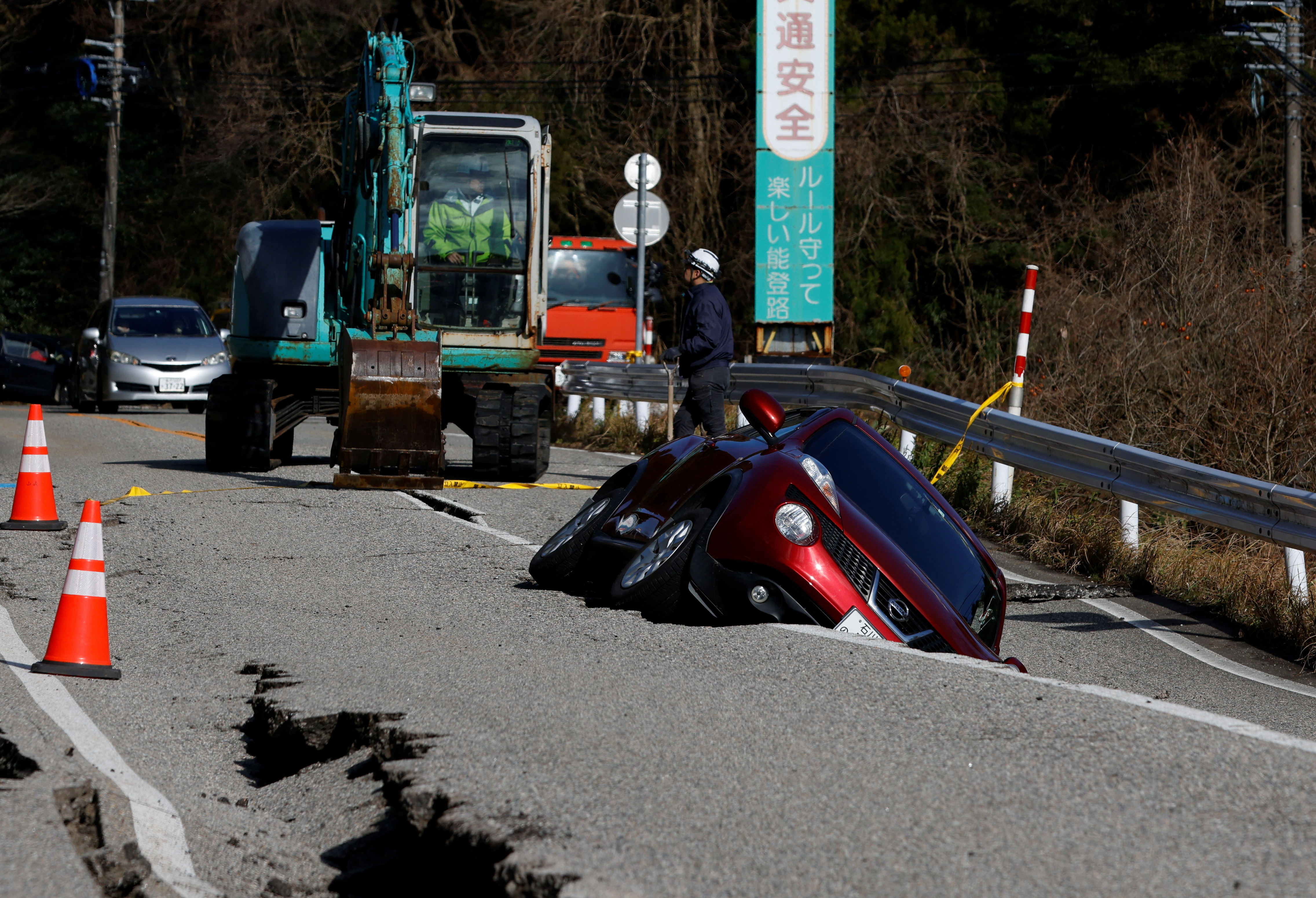 A view of a car stuck in a crack in the road, following an earthquake, near Ujima, Ishikawa prefecture, Japan January 2, 2024.