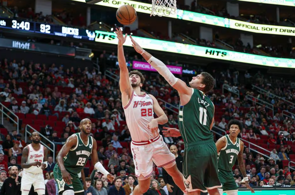 Houston Rockets center Alperen Sengun (28) shoots the ball as Milwaukee Bucks center Brook Lopez (11) defends during the fourth quarter at Toyota Center in Houston, Texas, Jan. 6, 2024.