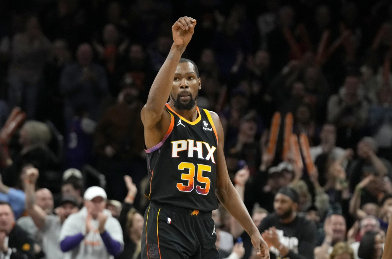 Phoenix Suns forward Kevin Durant gestures after he made a 3-pointer against the Sacramento Kings during the second half of an NBA game Tuesday, Jan. 16, 2024, in Phoenix.
