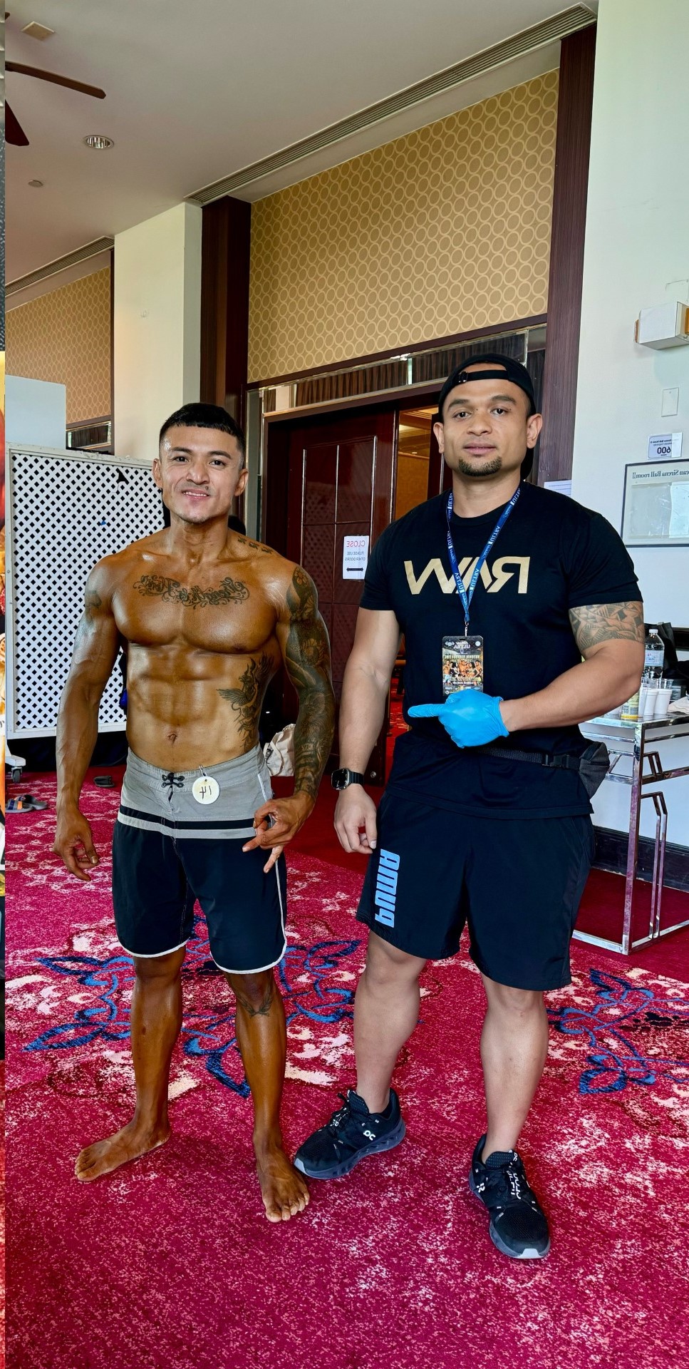 Mark Espeleta, left, poses with Joel Tudela of Health City Guam before competing in the 2023 NPC Guam Bodybuilding Championships on Saturday night at the Royal Laguna Guam Resort.