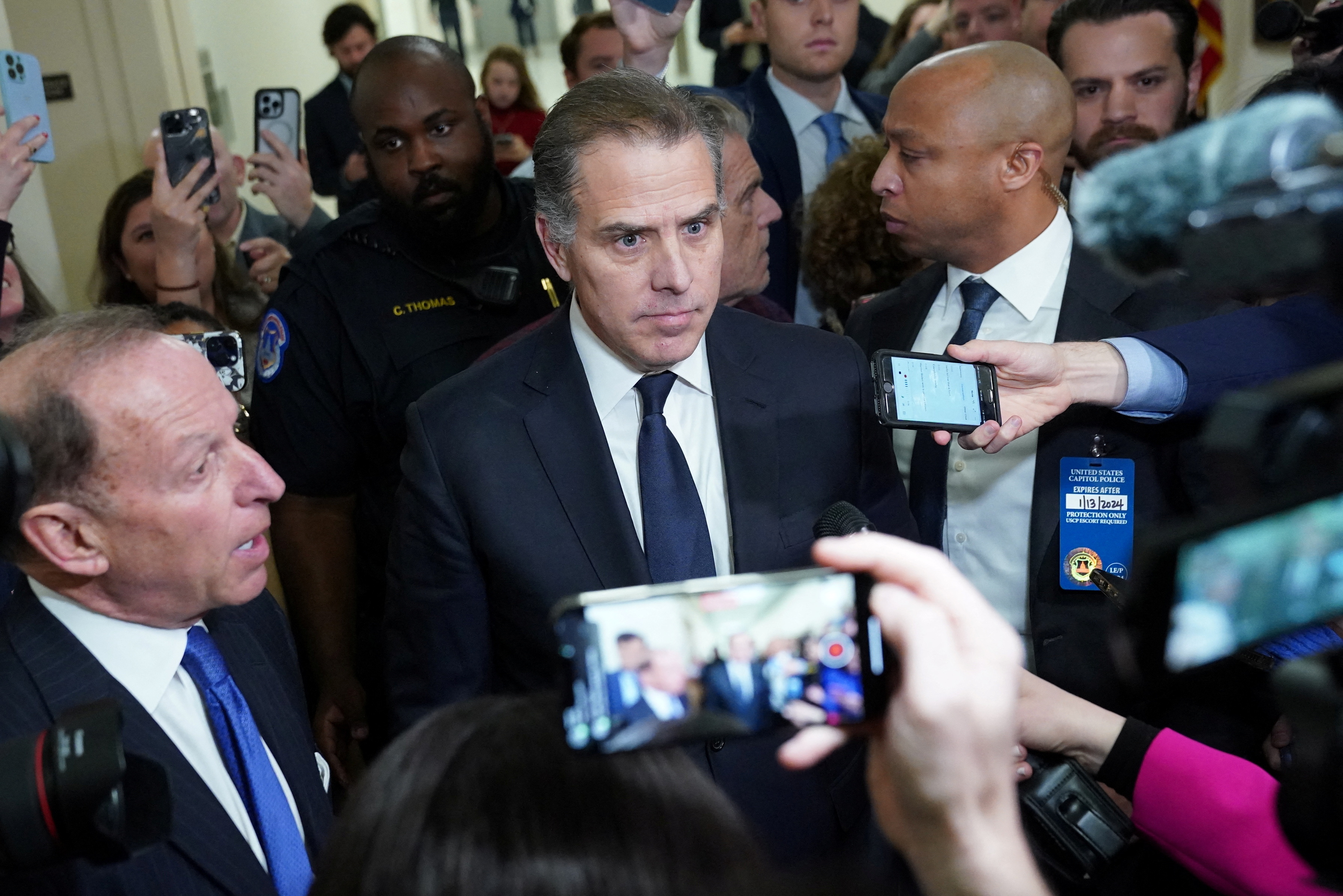 Hunter Biden, son of U.S. President Joe Biden, listens to his attorney Abbe Lowell as they depart following a surprise appearance at a House Oversight Committee markup and meeting to vote on whether to hold Biden in contempt of Congress for failing to respond to a request to testify to the House last month, on Capitol Hill in Washington, U.S., January 10, 2024. 